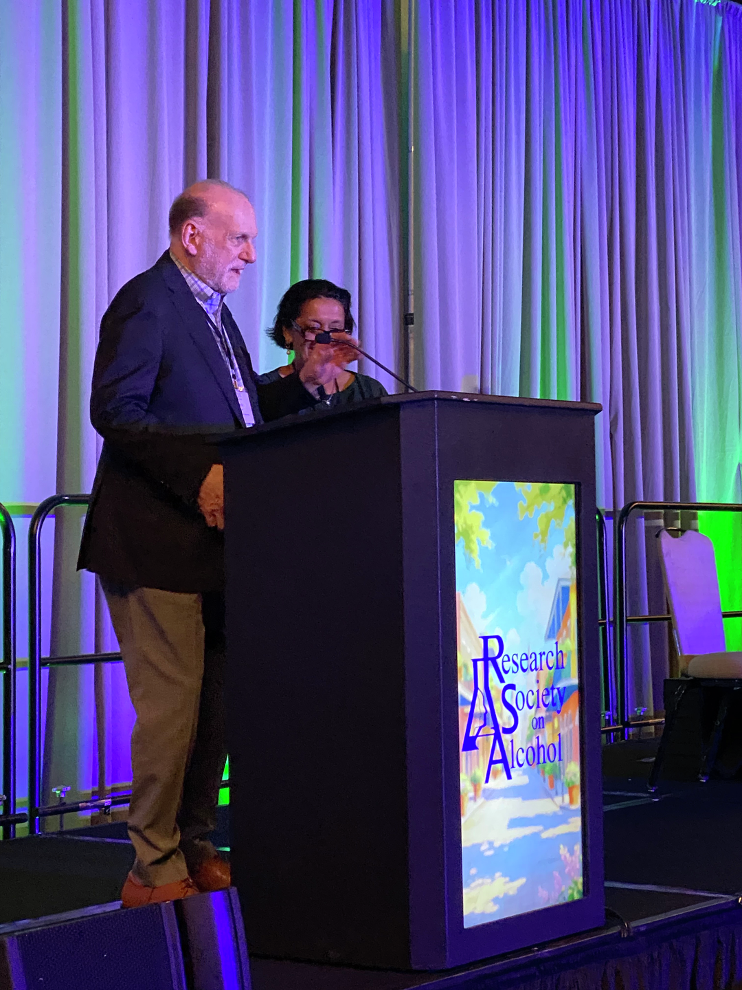Henry Kranzler standing behind a podium at a conference