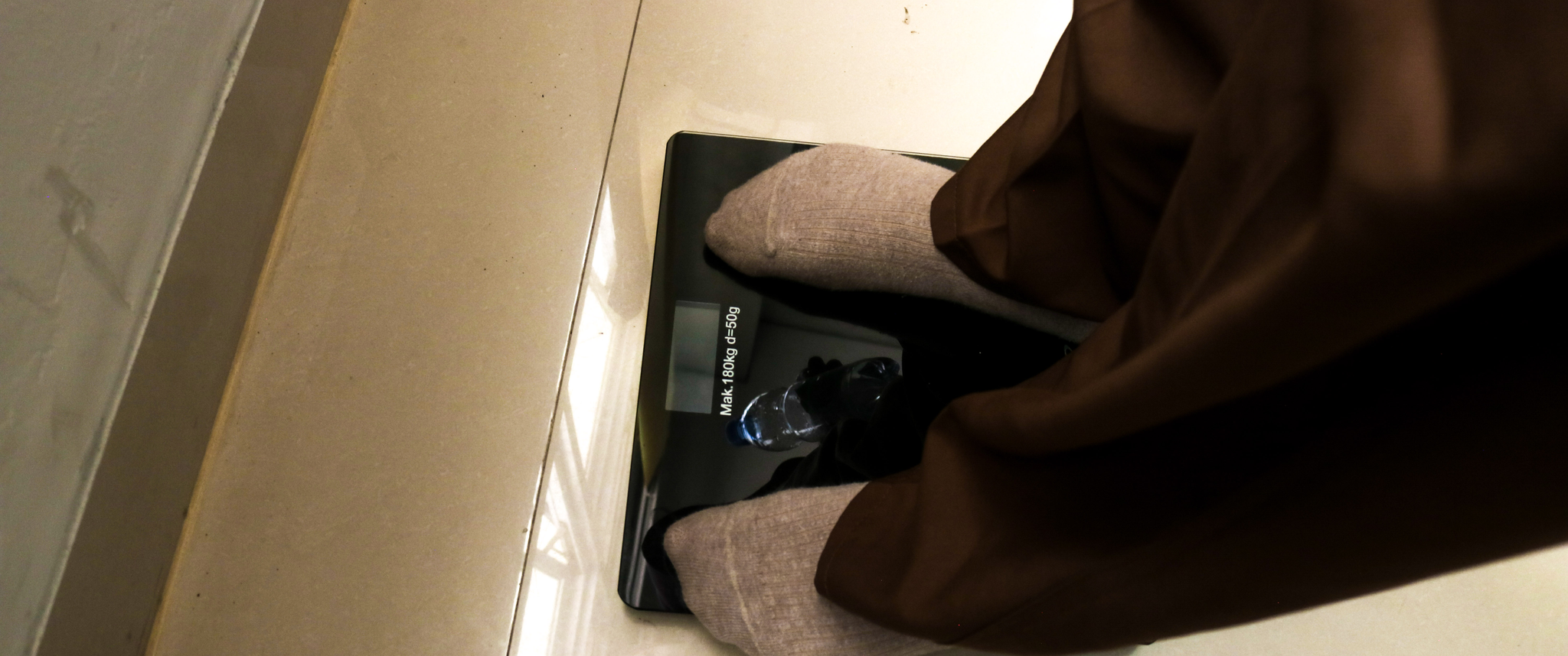 Person standing on scale being weighed