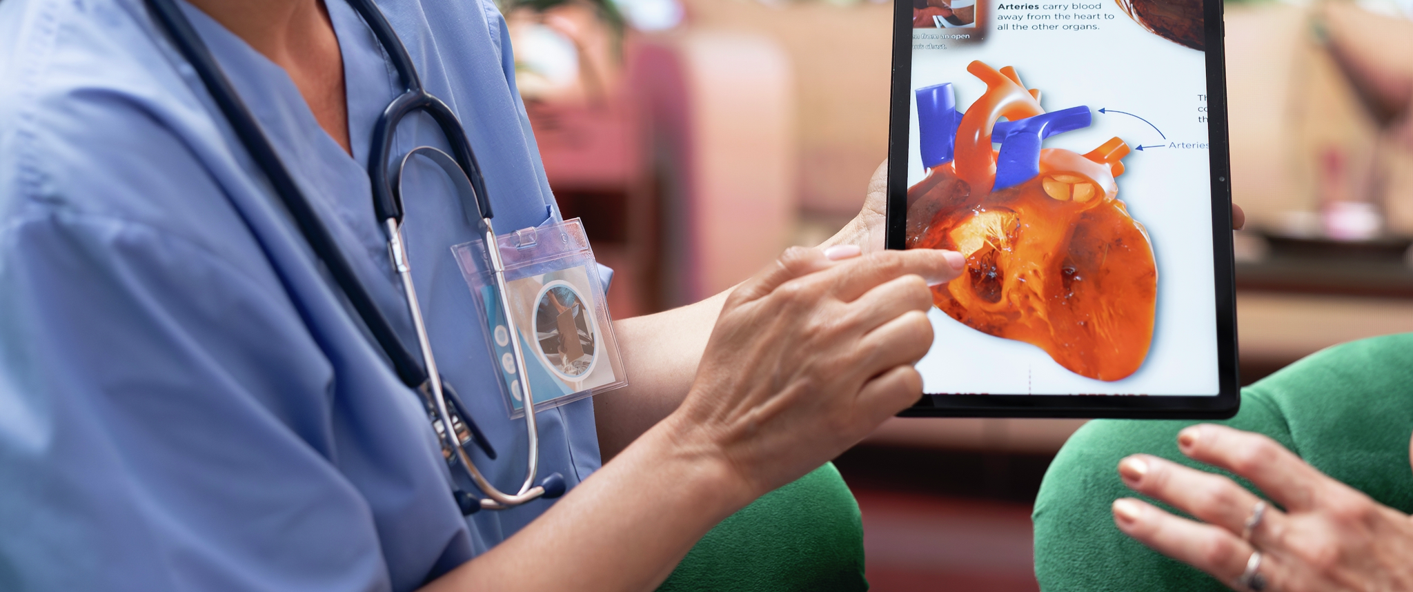 Skilled nurse explaining a heart condition or disease to elderly patients, cardiovascular system illustration during checkup visit at home. Healthcare and senior support for healthy recovery.
