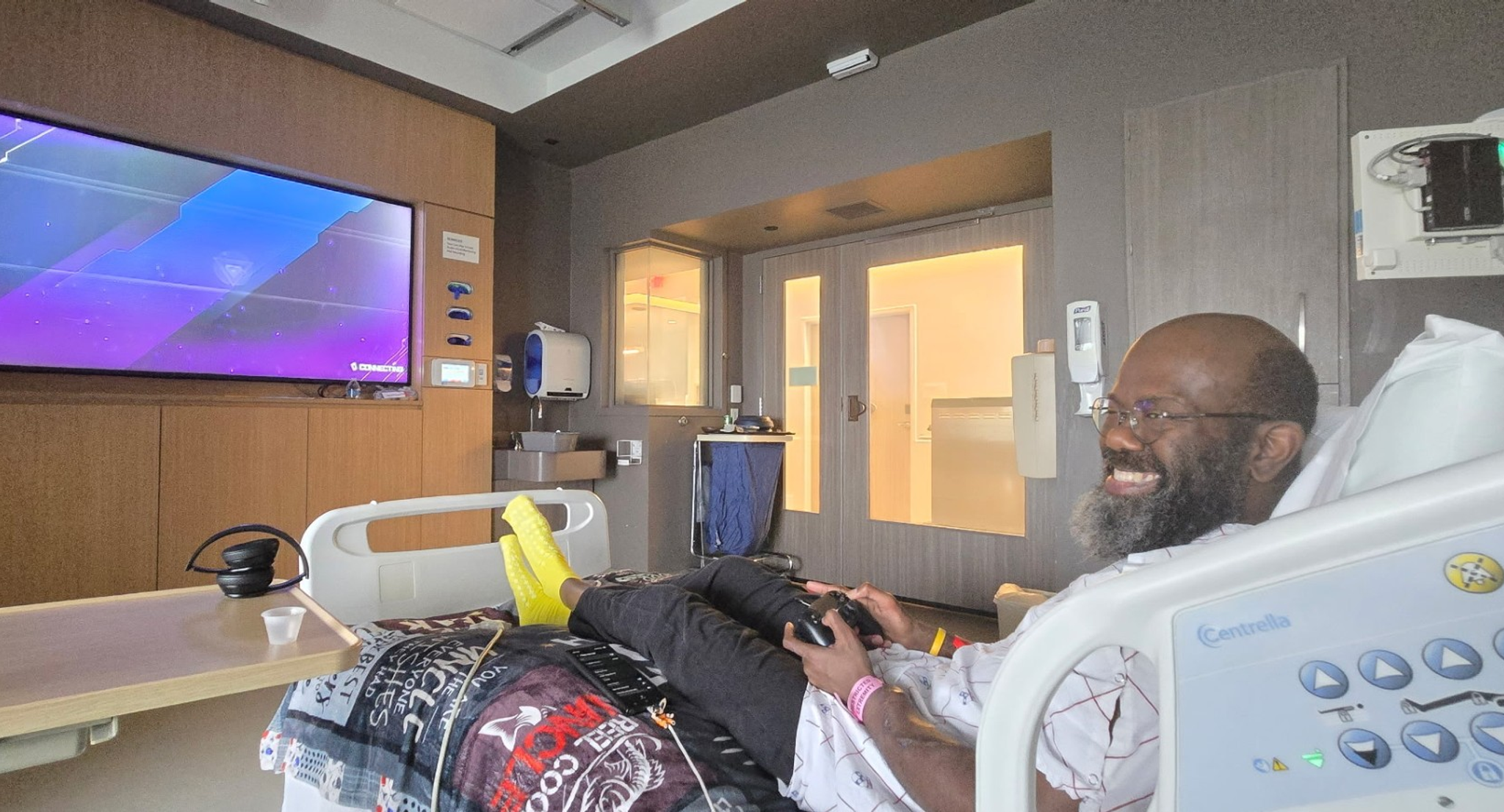 Andrew Boyd sitting in hospital bed