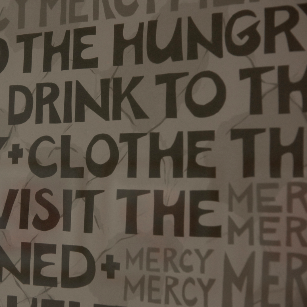 A poster displays text such as "feed the hungry, give drink to the thirsty"