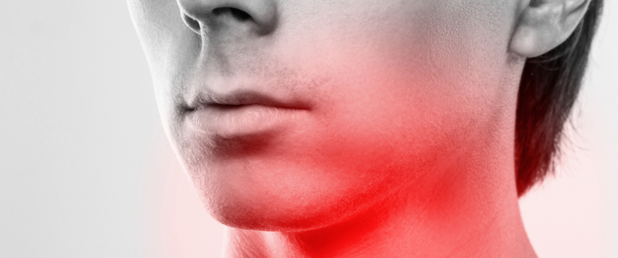 A black and white photo of a person's lower face and neck with a red gradient overlapping their throat area