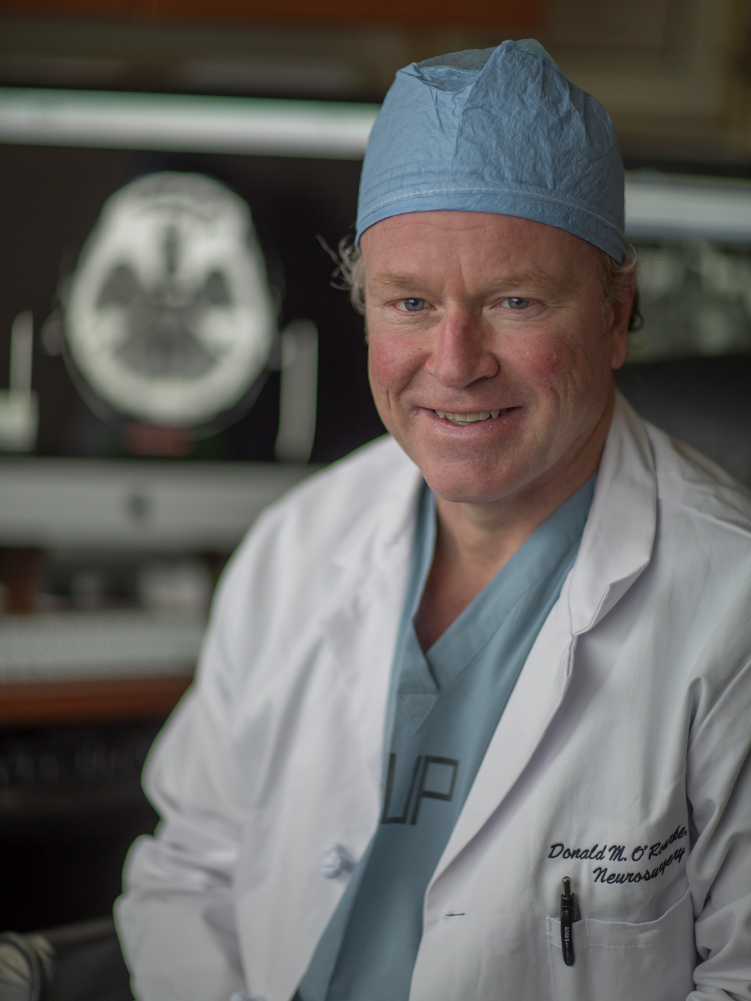 Donald O'Rourke wearing scrubs and a surgical cap