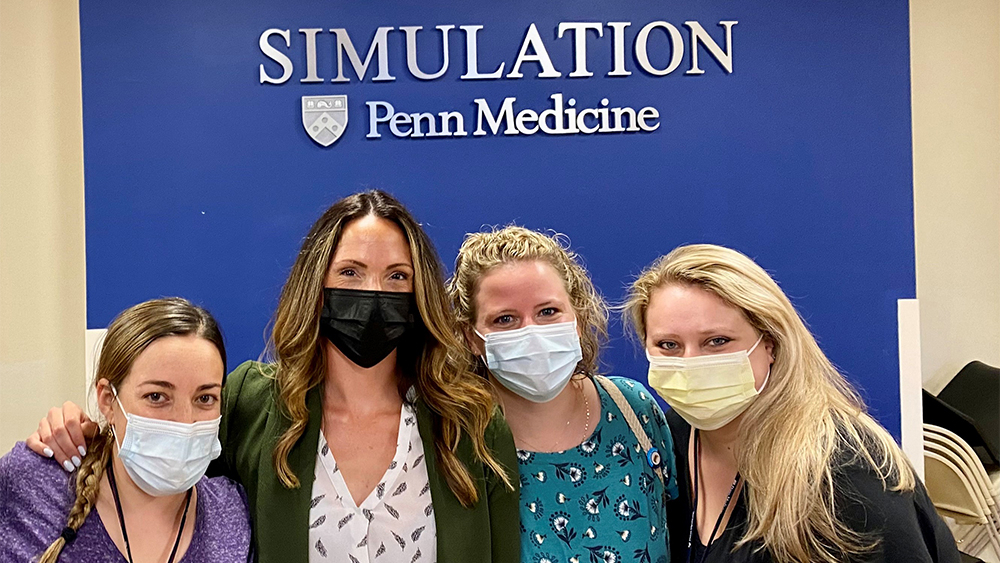 four women wearing masks