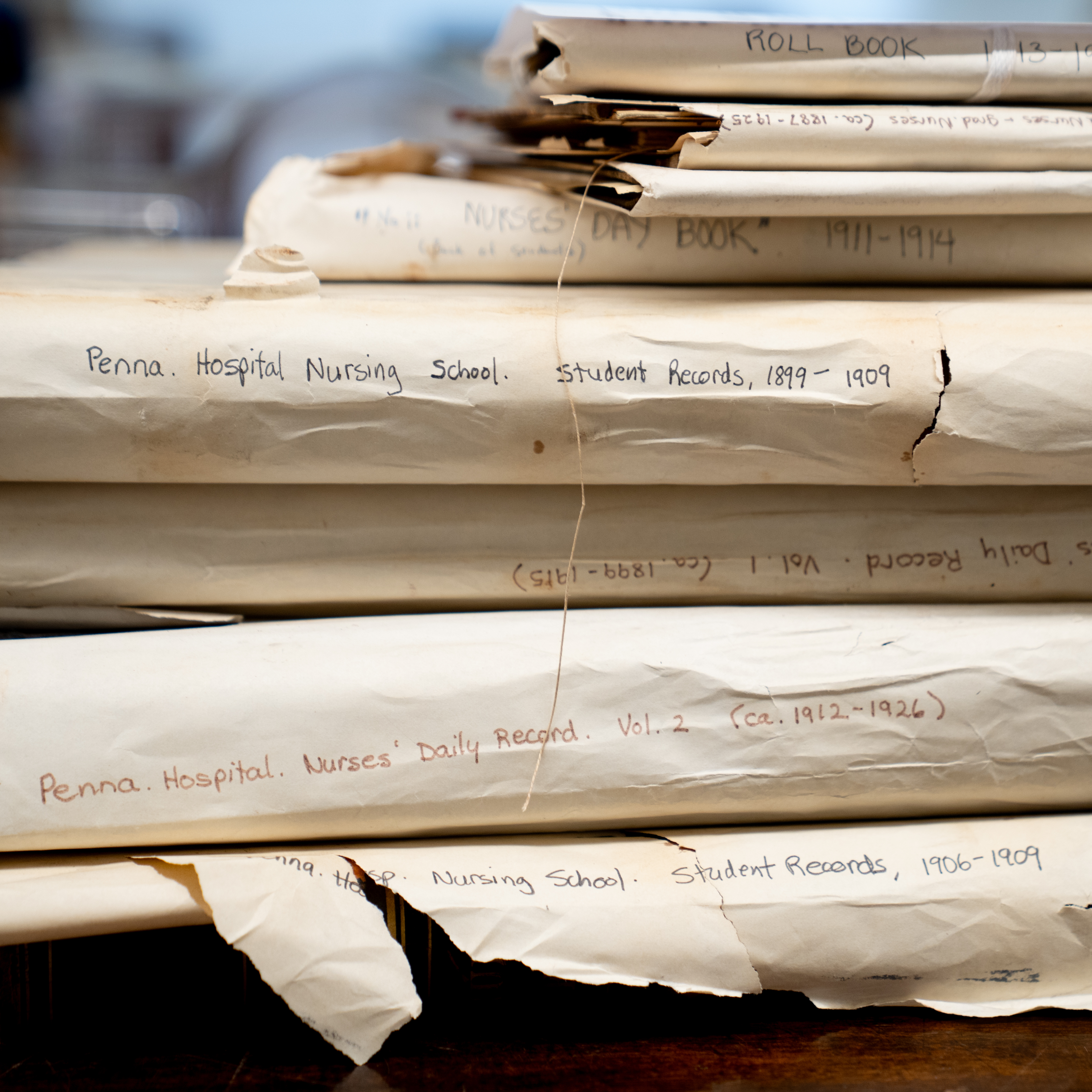 A stack of books documenting 20th century Pennsylvania Hospital nursing school records