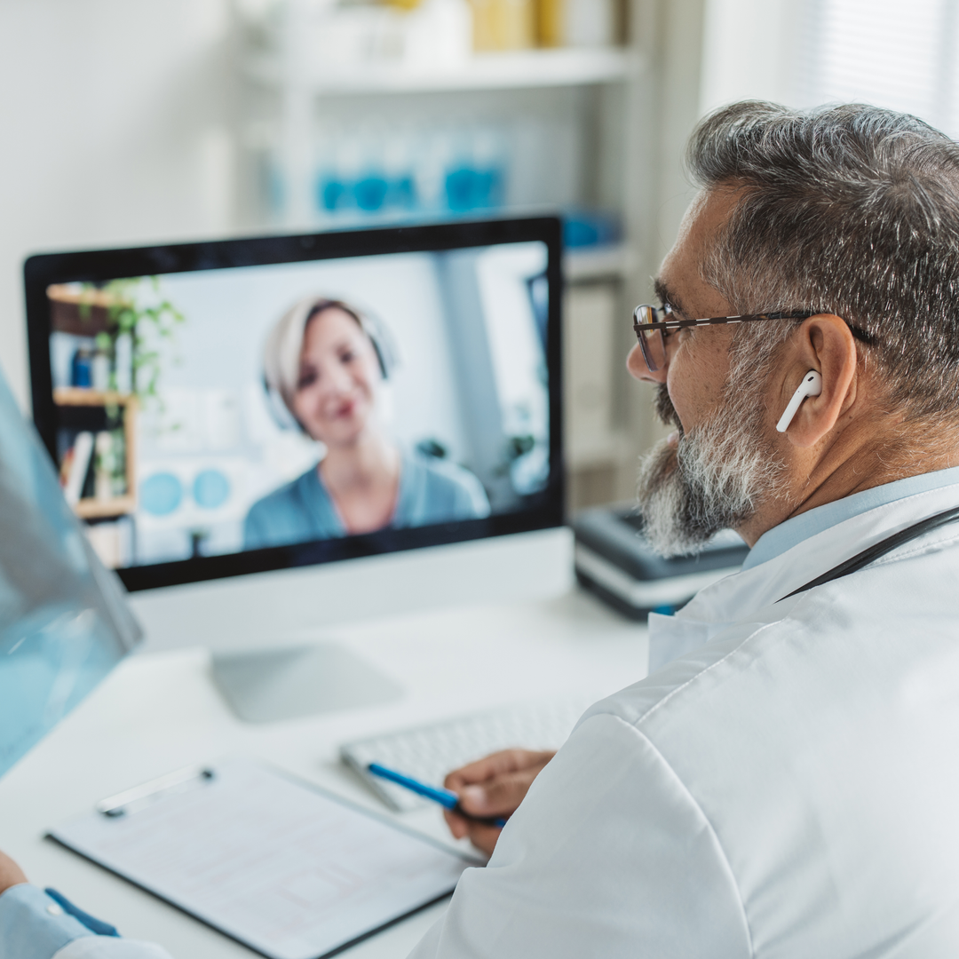 Doctor talking while explaining medical treatment to patient through a video call in the consultation. 