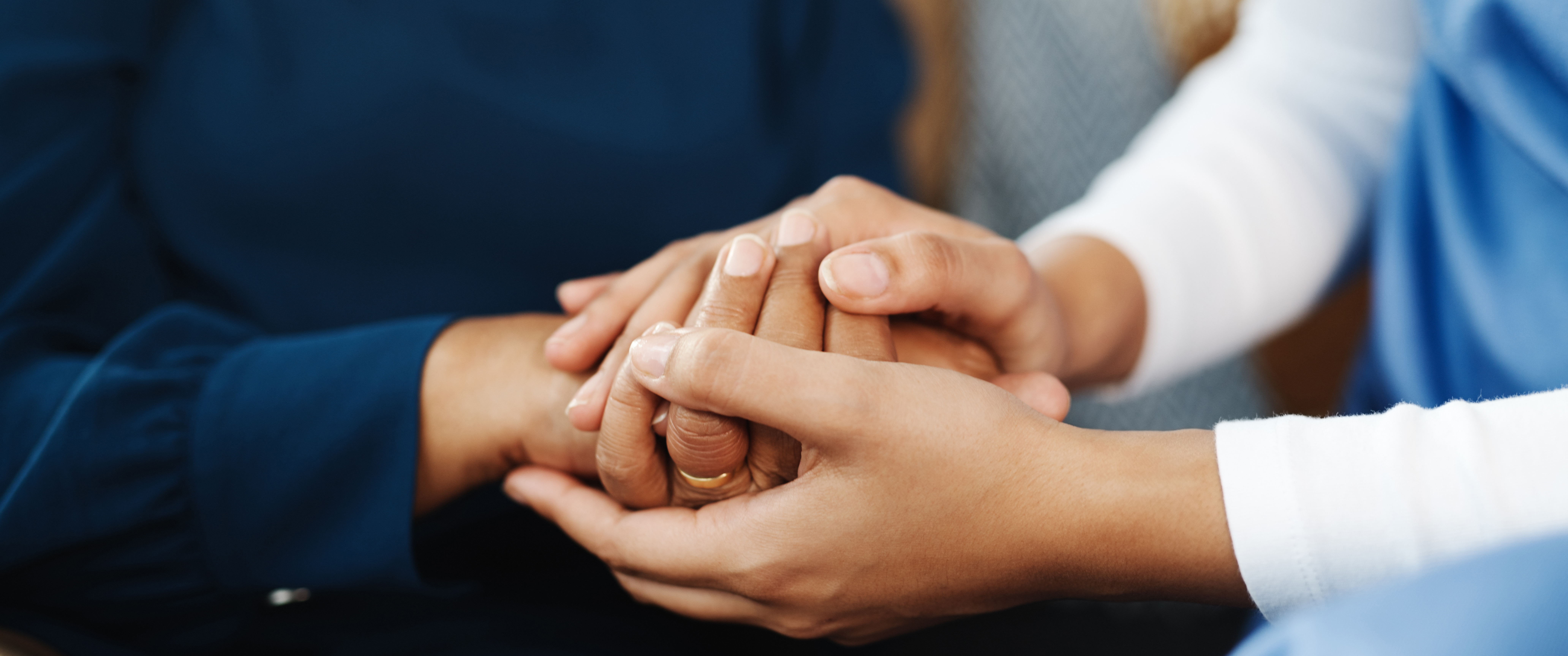 Cropped shot of an unrecognizable nurse holding a patient's hand inside of a doctor's office during the day