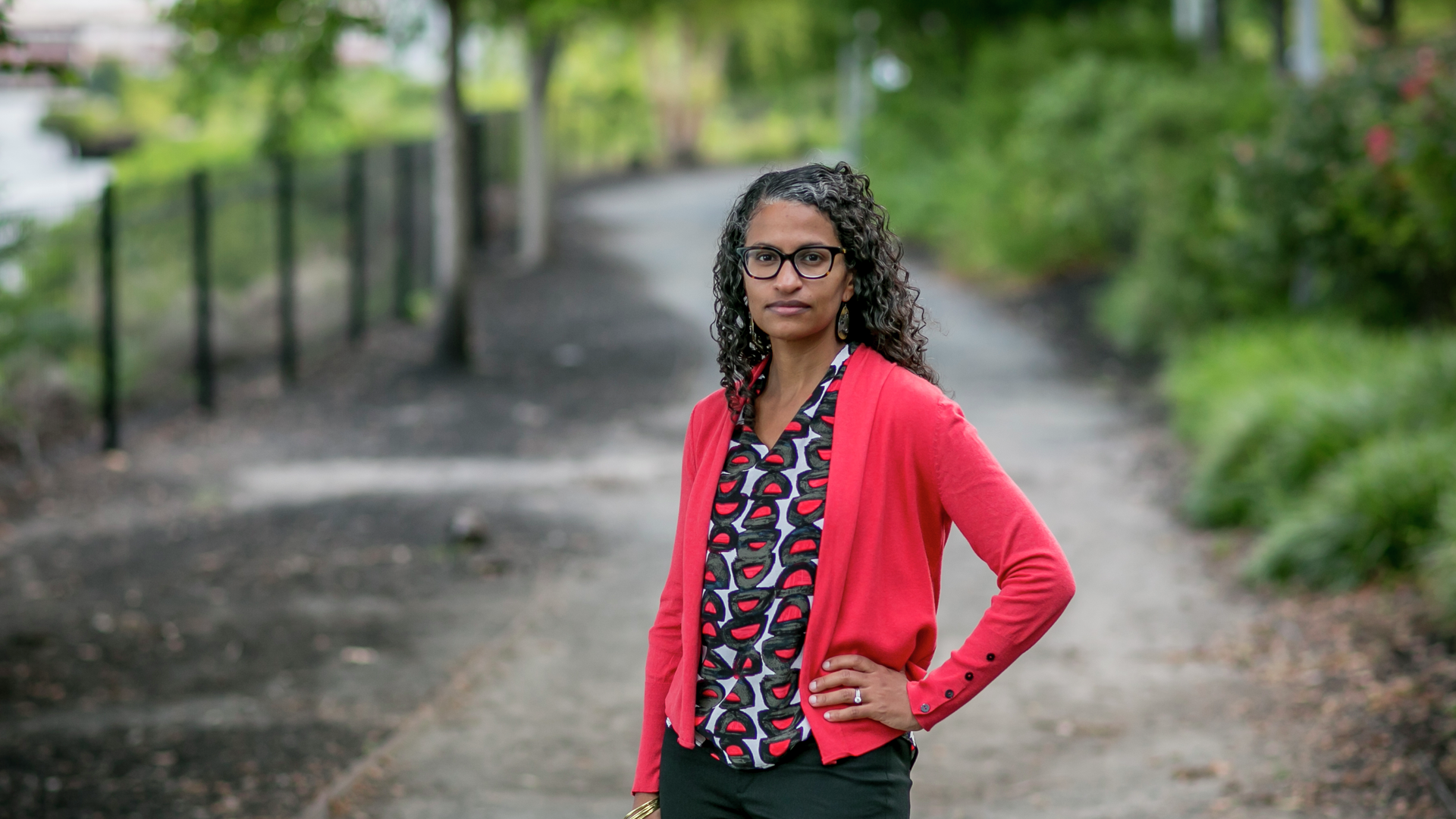 Eugenia South MD in business attire, standing outside on path