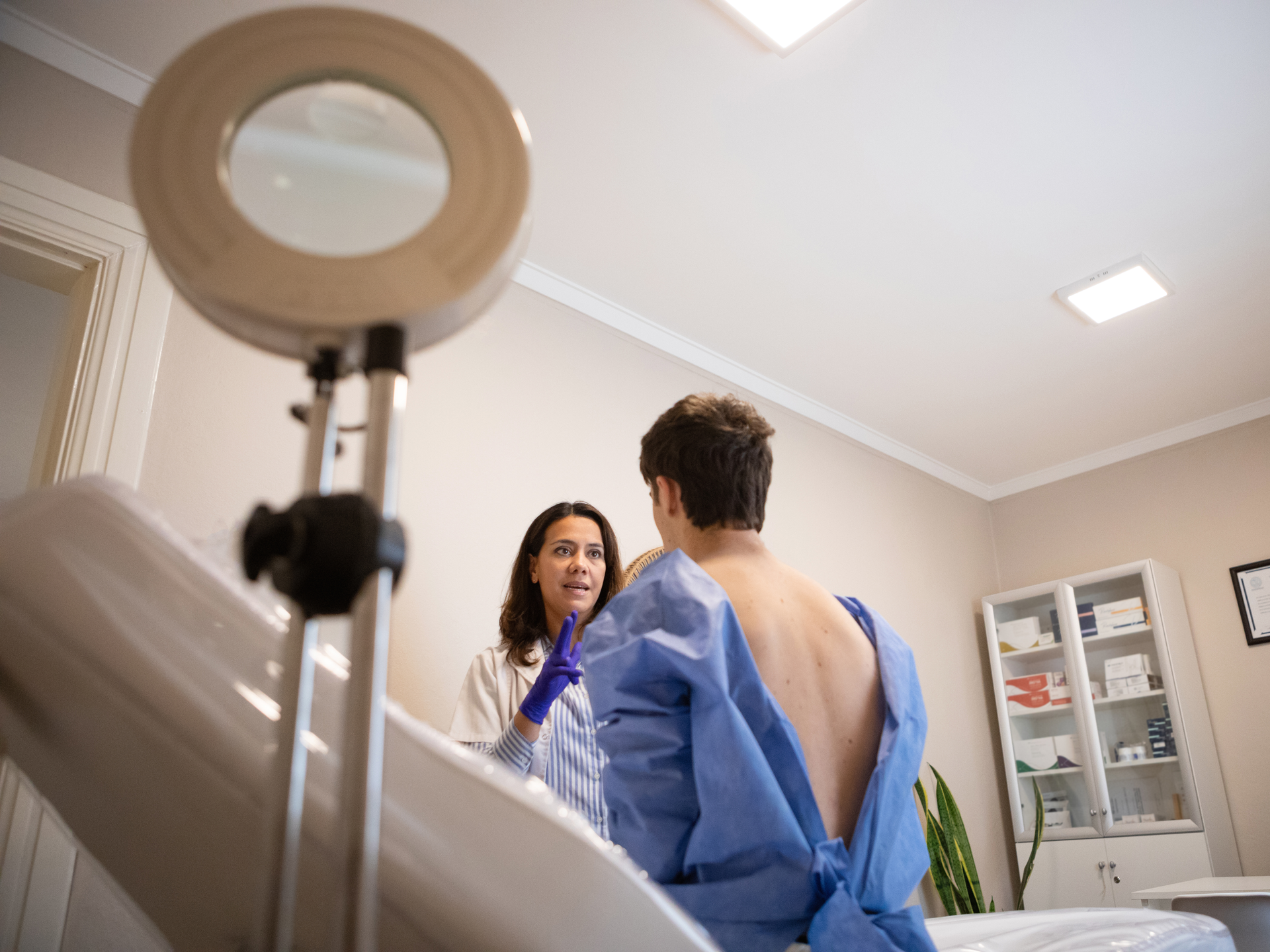 Dermatologist consulting with patient in a medical office. 