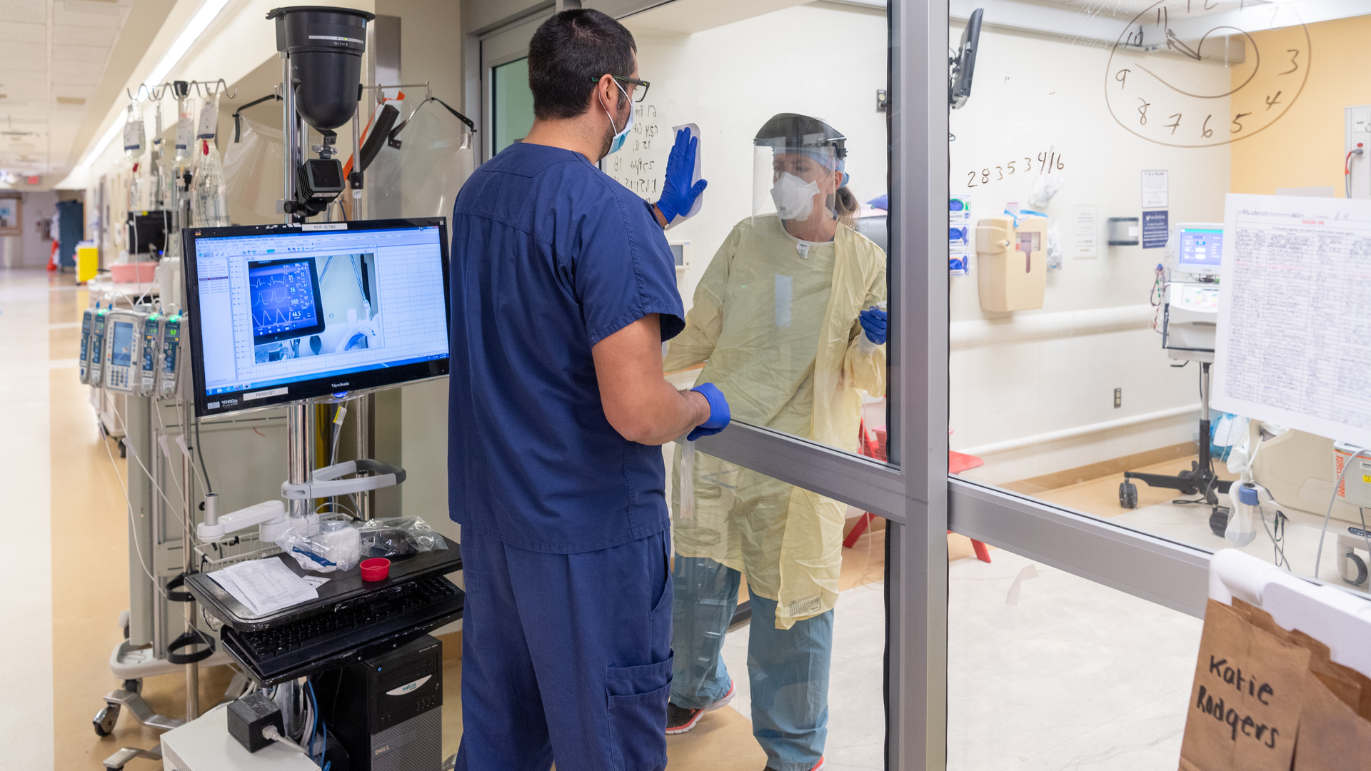 ICU staff Communicating through the glass during the early days of the pandemic