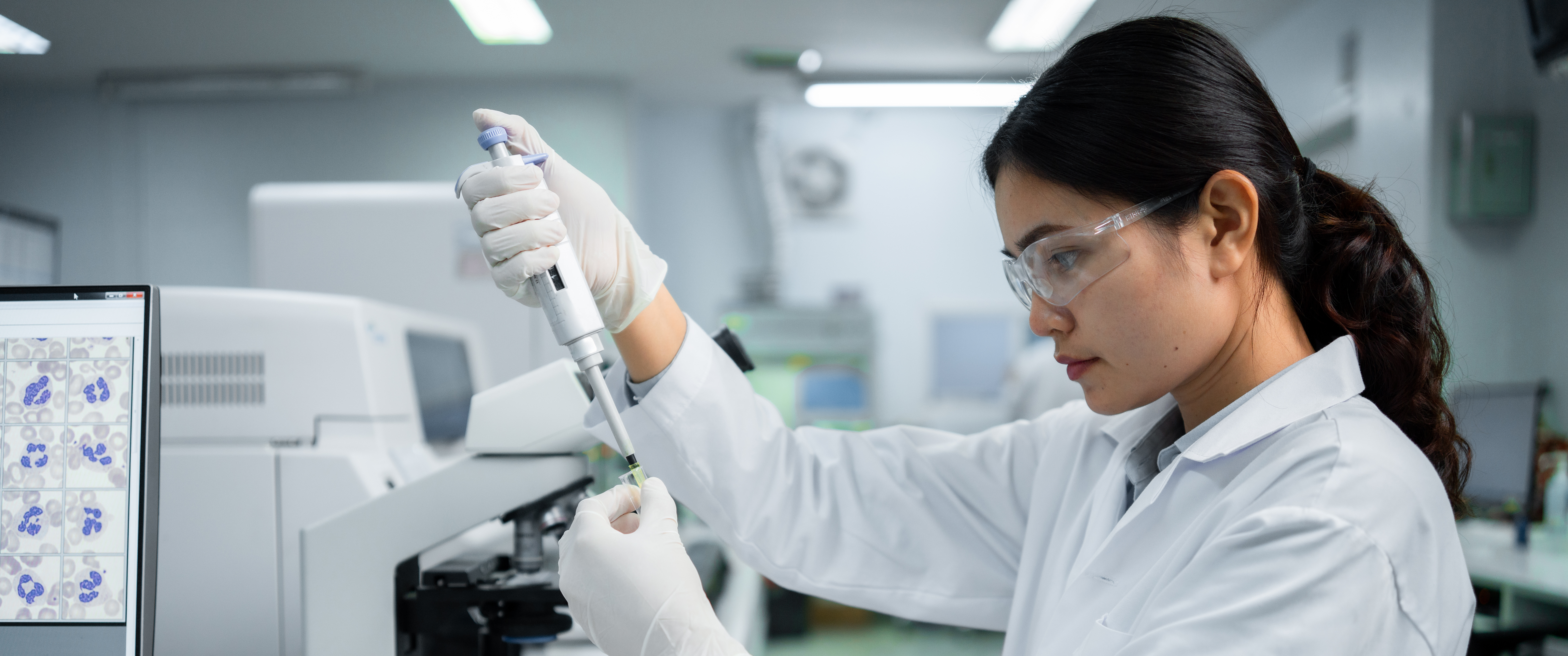 Researcher tests samples in lab with pipette