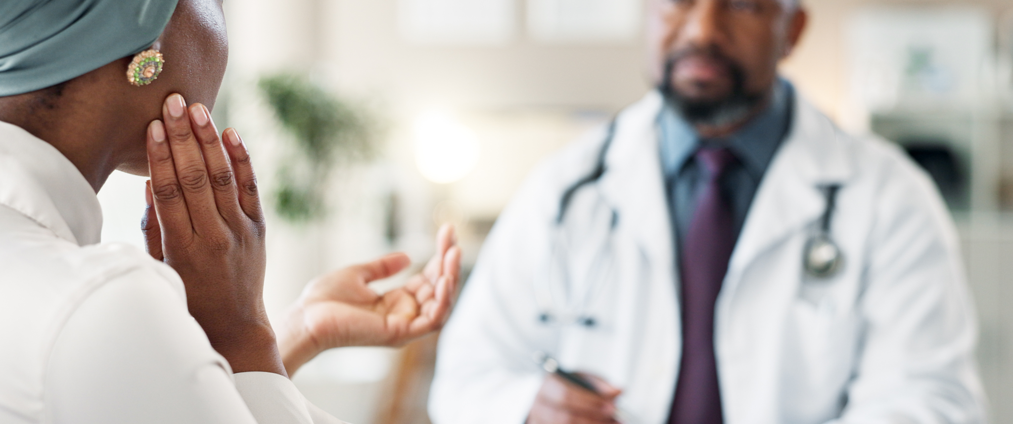 Patient consulting with doctor about jaw pain and tmj treatment.