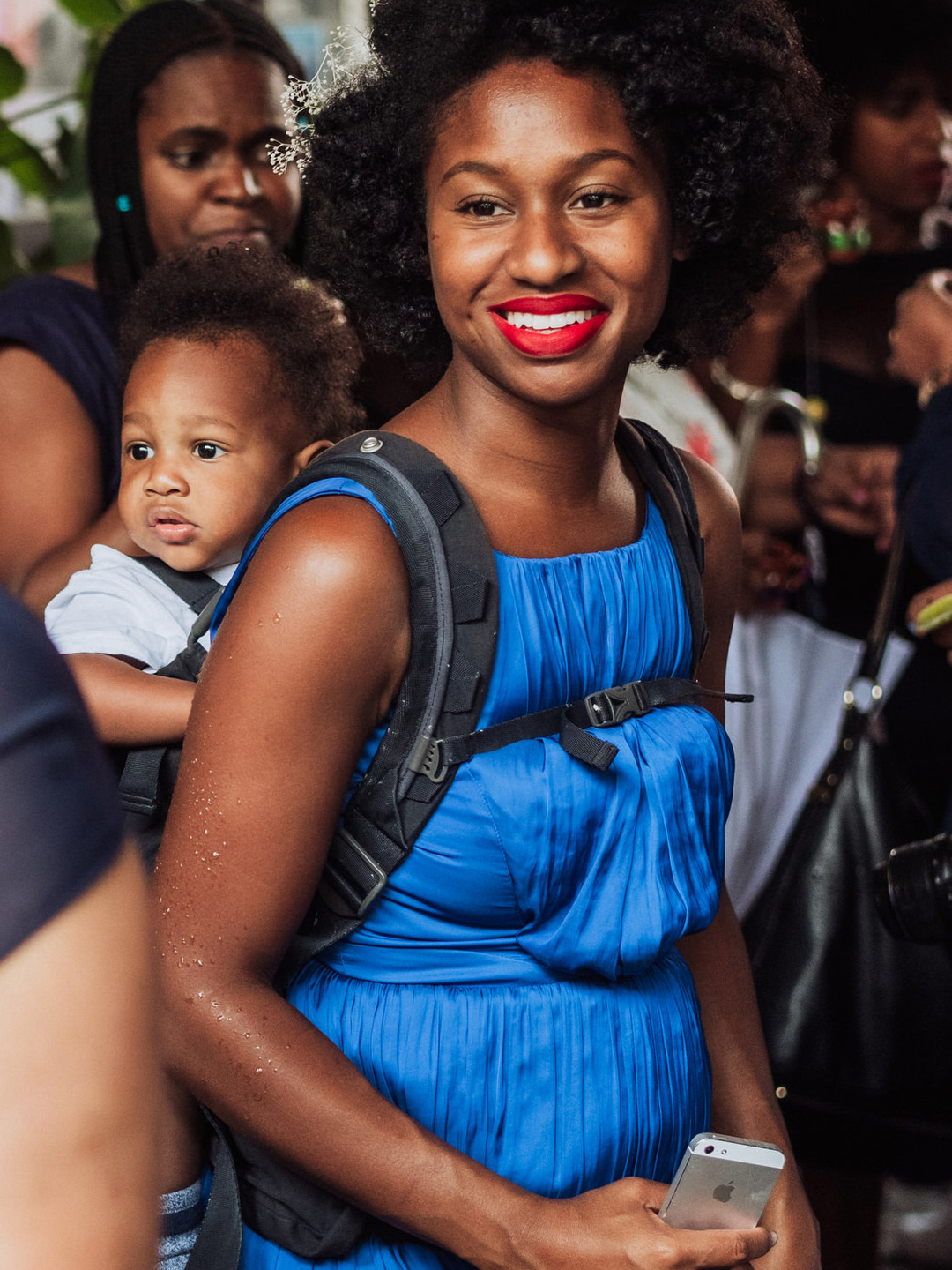 Whitney Robinson with a baby in a carrier on her back