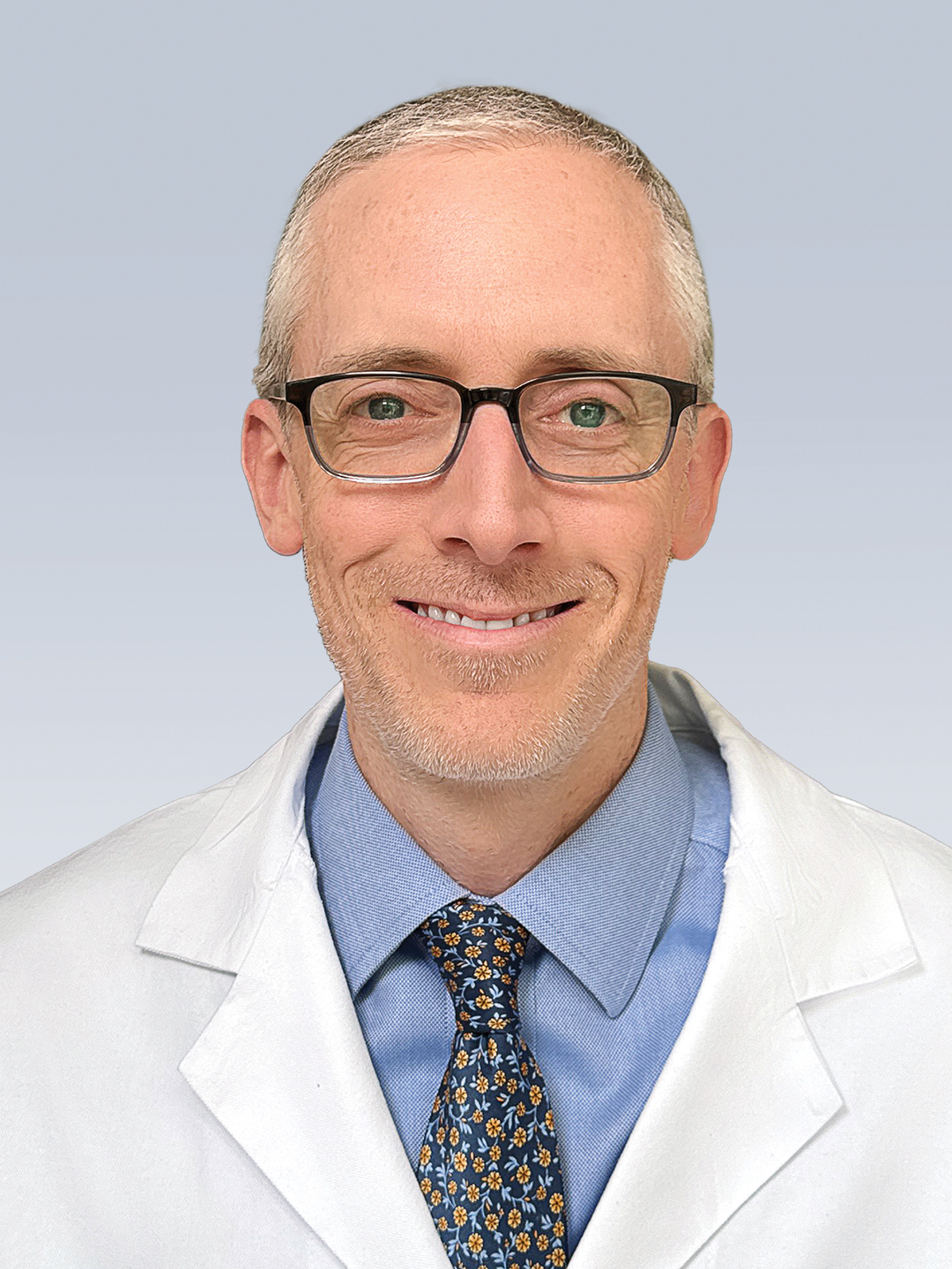 Headshot of Joseph Teel, MD, in a white coat