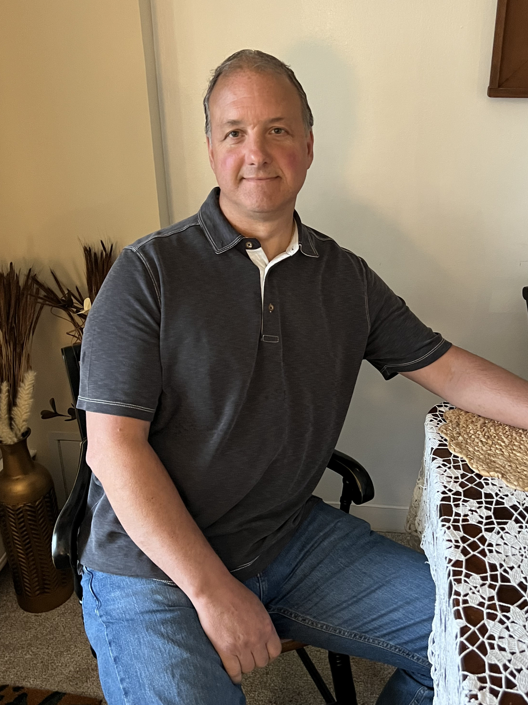 Ed Schumacher, Jr. seated at a dining room table