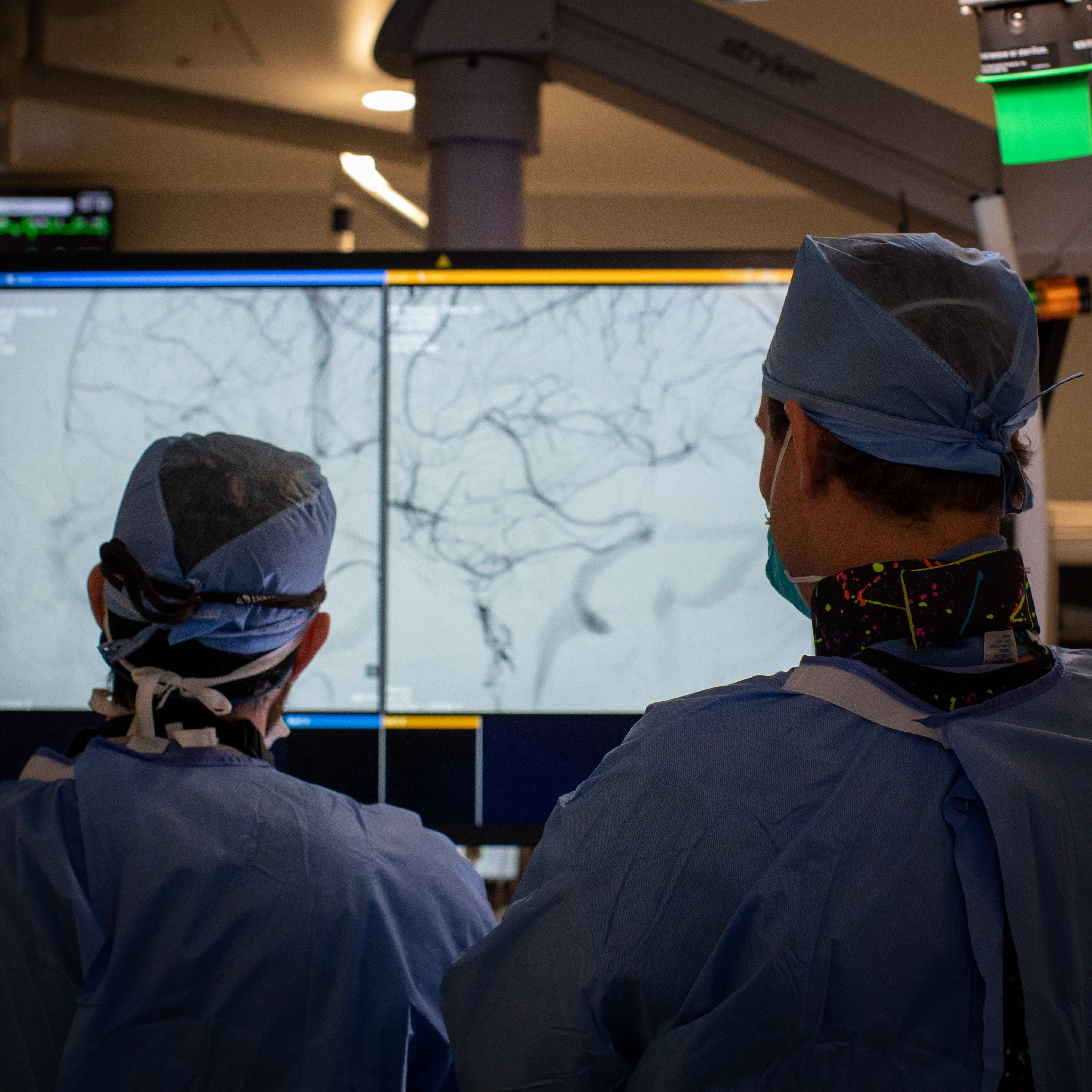 Dr. Burkhardt and a Fellow looking at screen in surgery