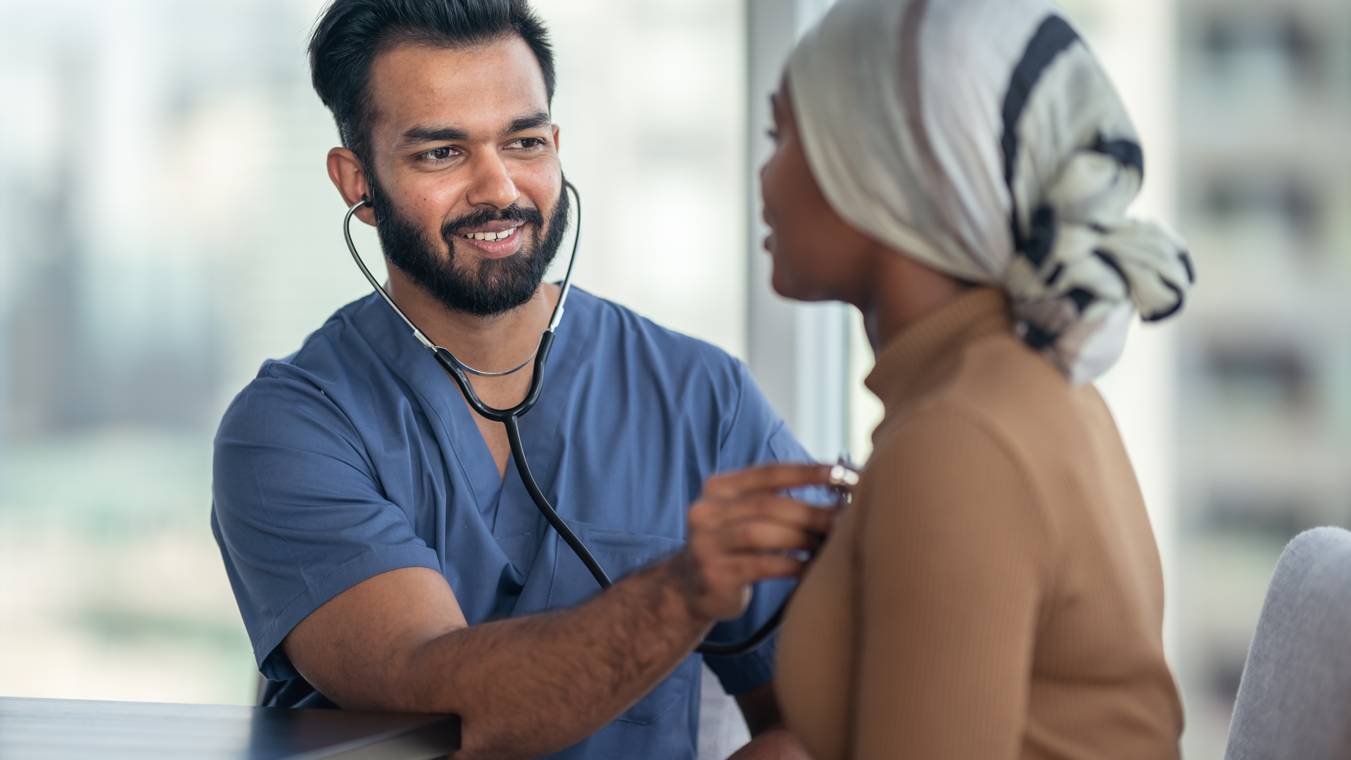 Medical professional using stethoscope to check patient's heart and lungs
