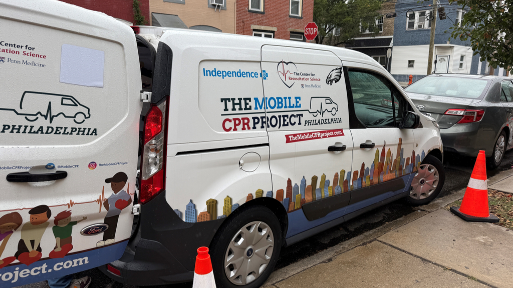 The Mobile CPR Project van parked outside next to the sidewalk.