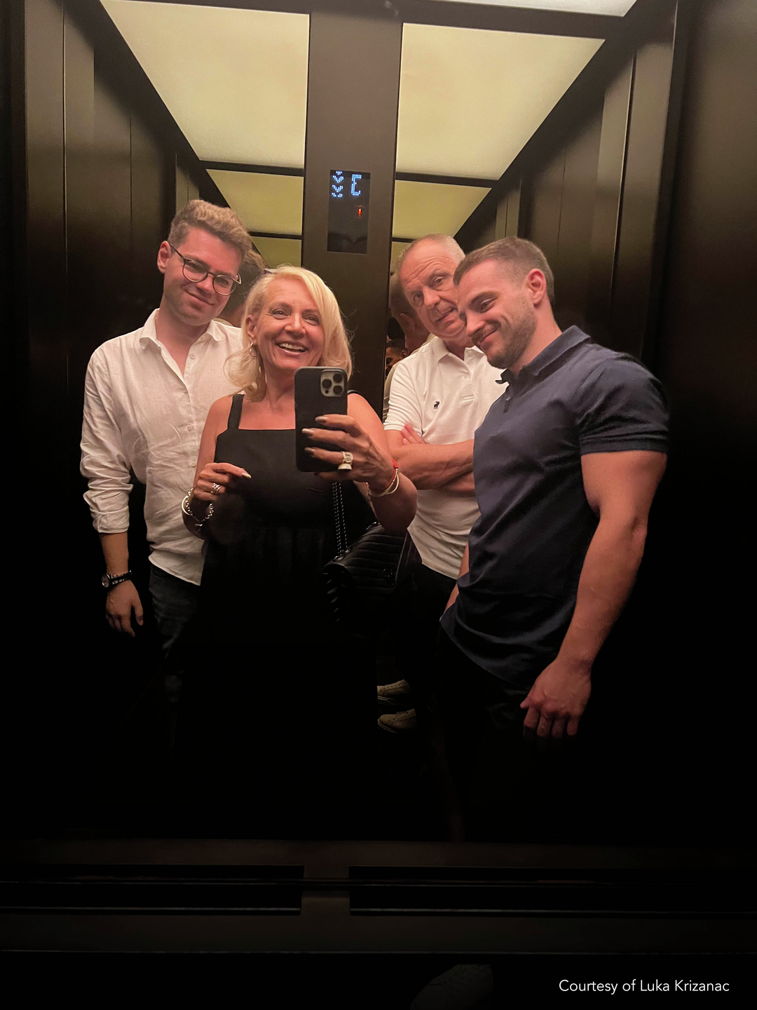 Luka Krizanac and his brother and parents standing in an elevator 