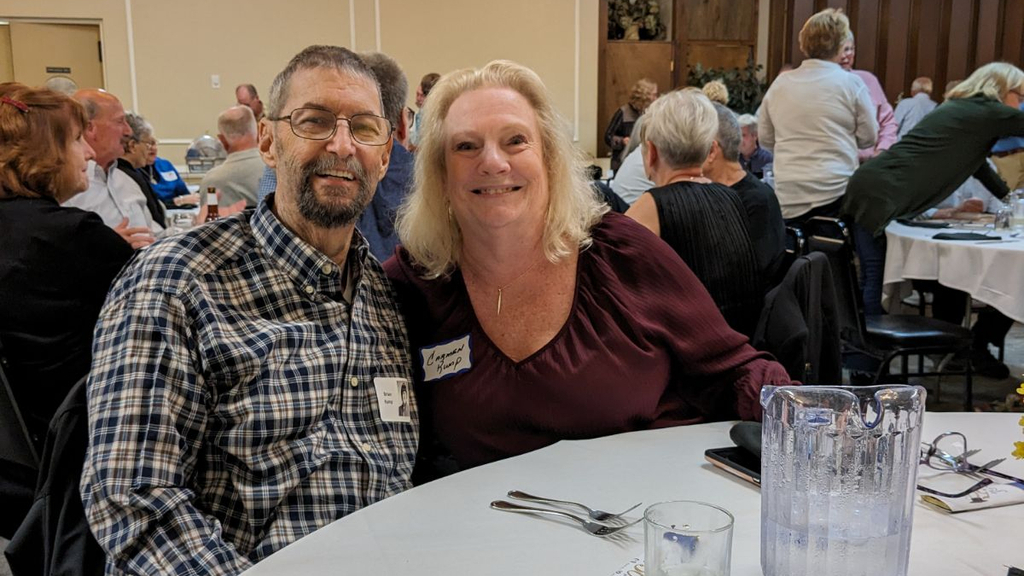 Brian and Carmen Rump at a banquet table