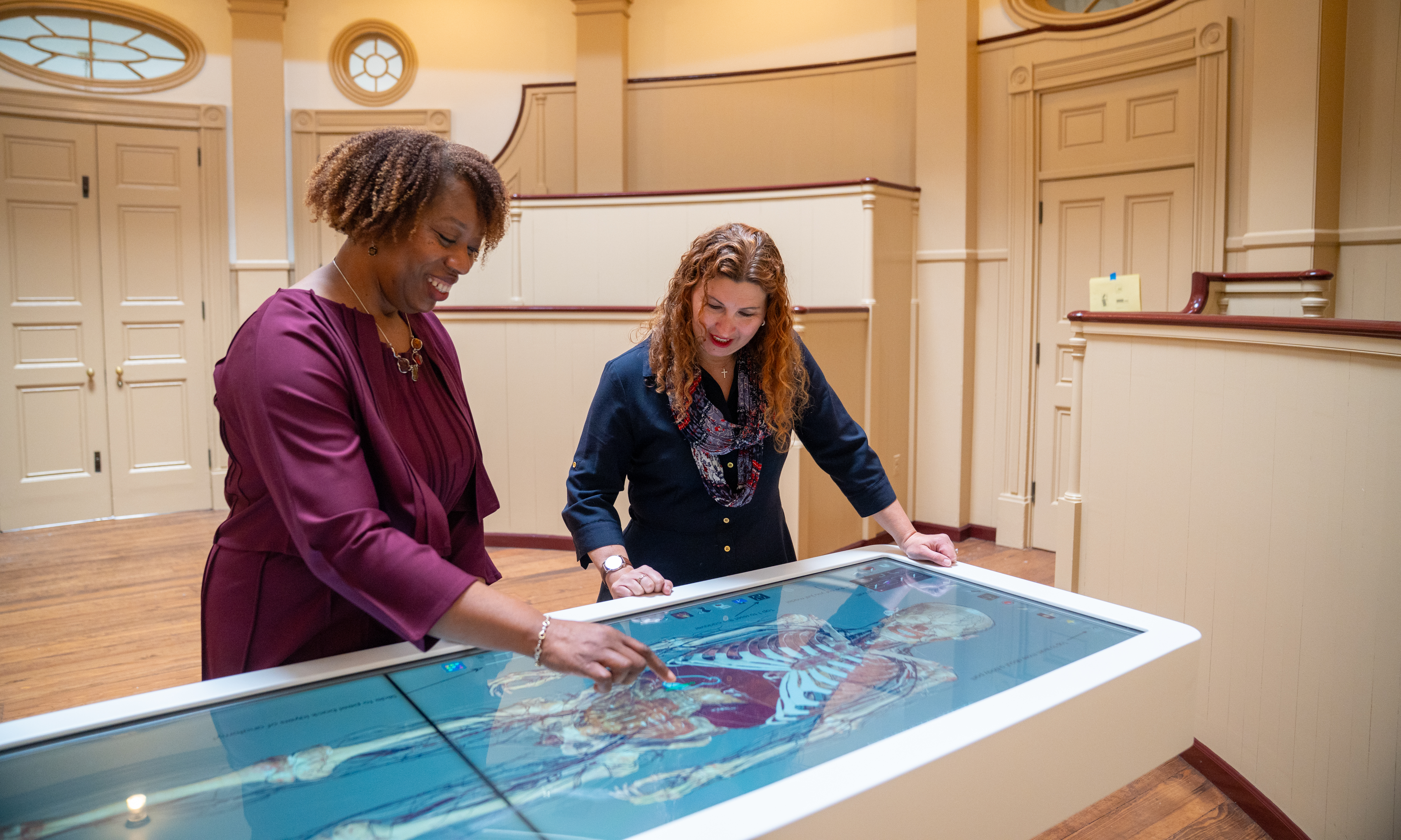 Stacey Peeples and Alicia Gresham interacting with the anatomage table screen