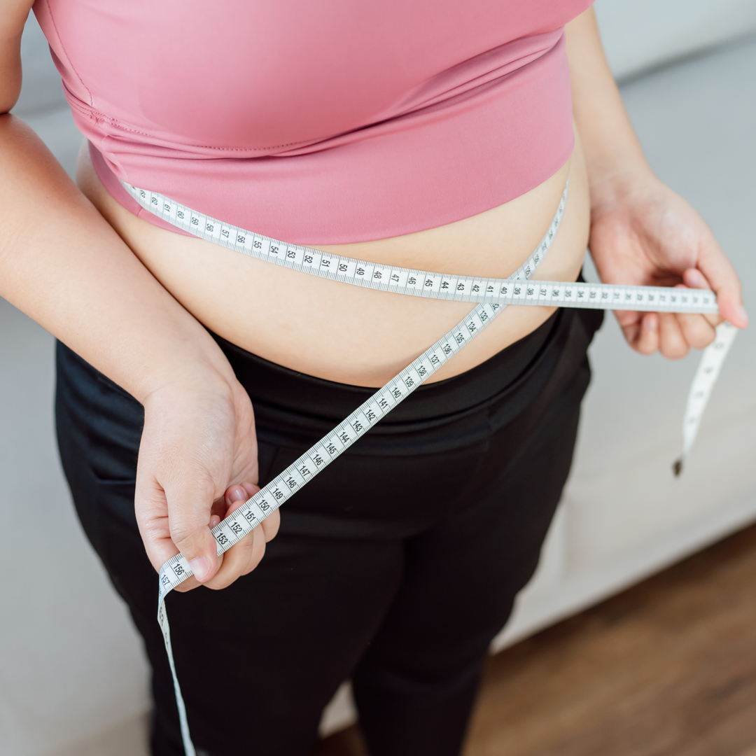 Obese Woman with fat belly in dieting concept. Overweight woman touching his fat belly and want to lose weight. 