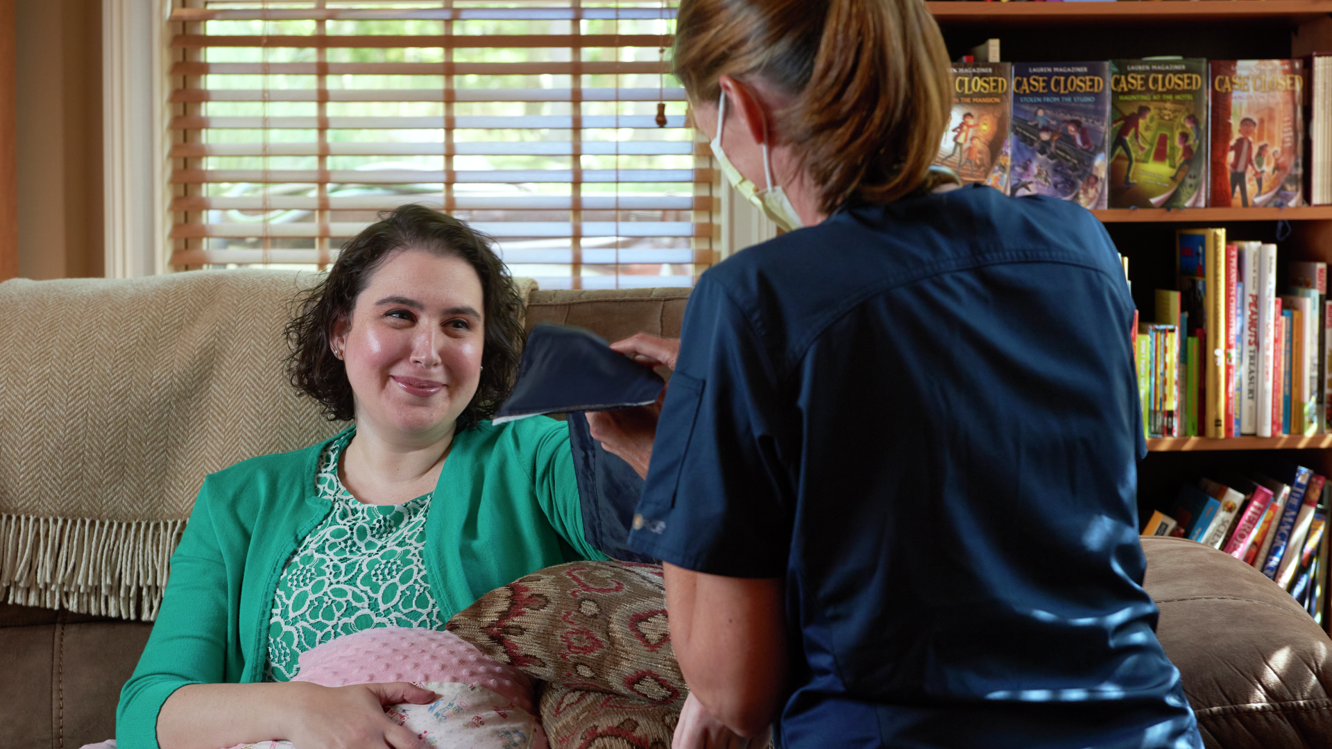 Penn Medicine Home Care nurse Erin McCarthy, RN, NP, provides follow-up care at home for Lauren Magaziner, an author of middle-grade fiction books, who had a preventive double mastectomy after learning she had a BRCA1 gene mutation. 