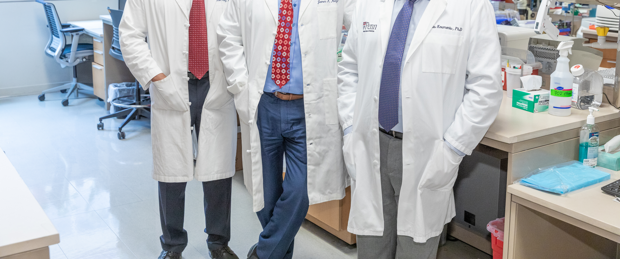 Group photo of Amit Maity, MD, PhD, James Metz, MD, and Constantinos Koumenis, PhD, in a research lab