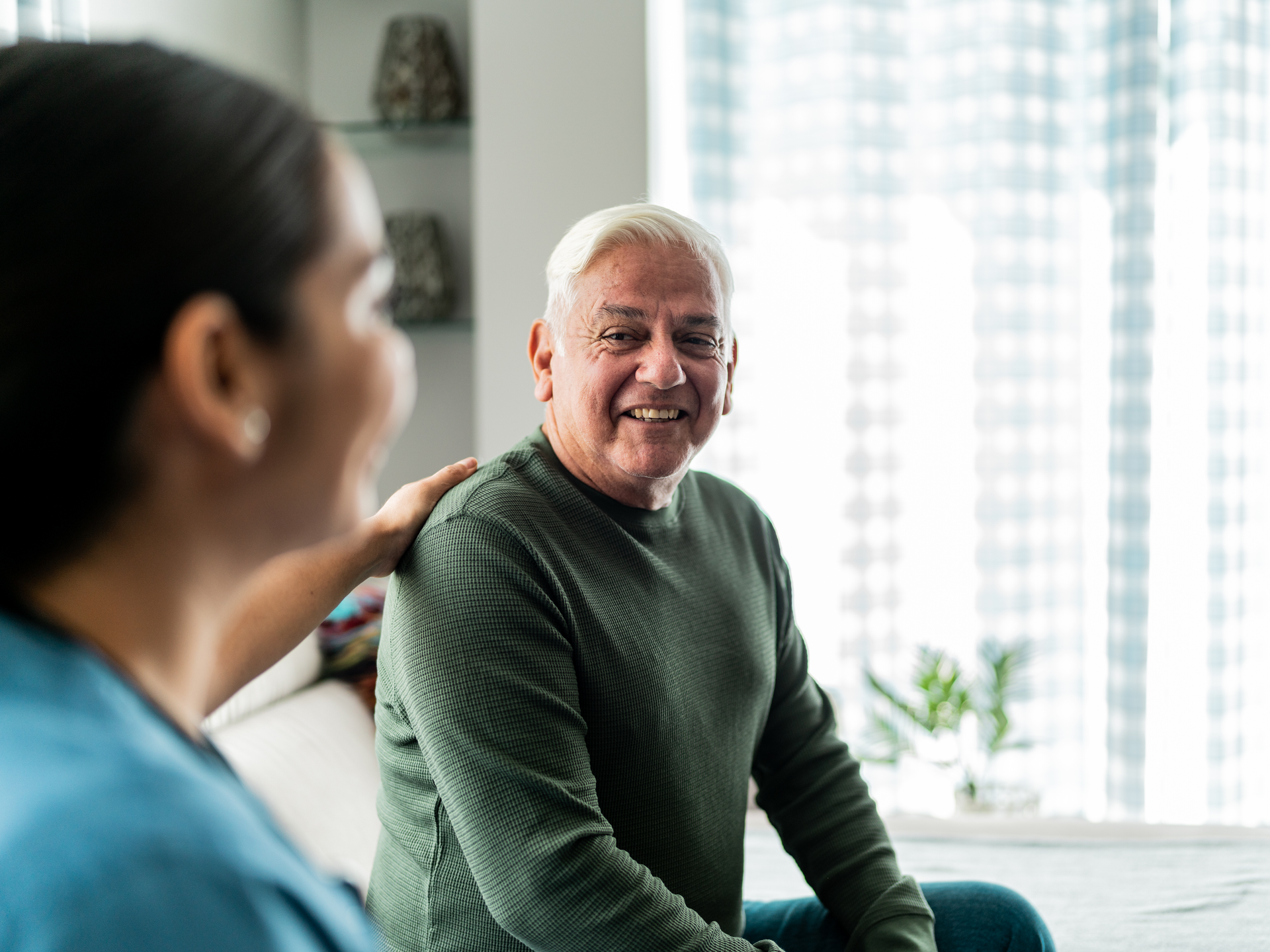 Senior man talking with caregiver