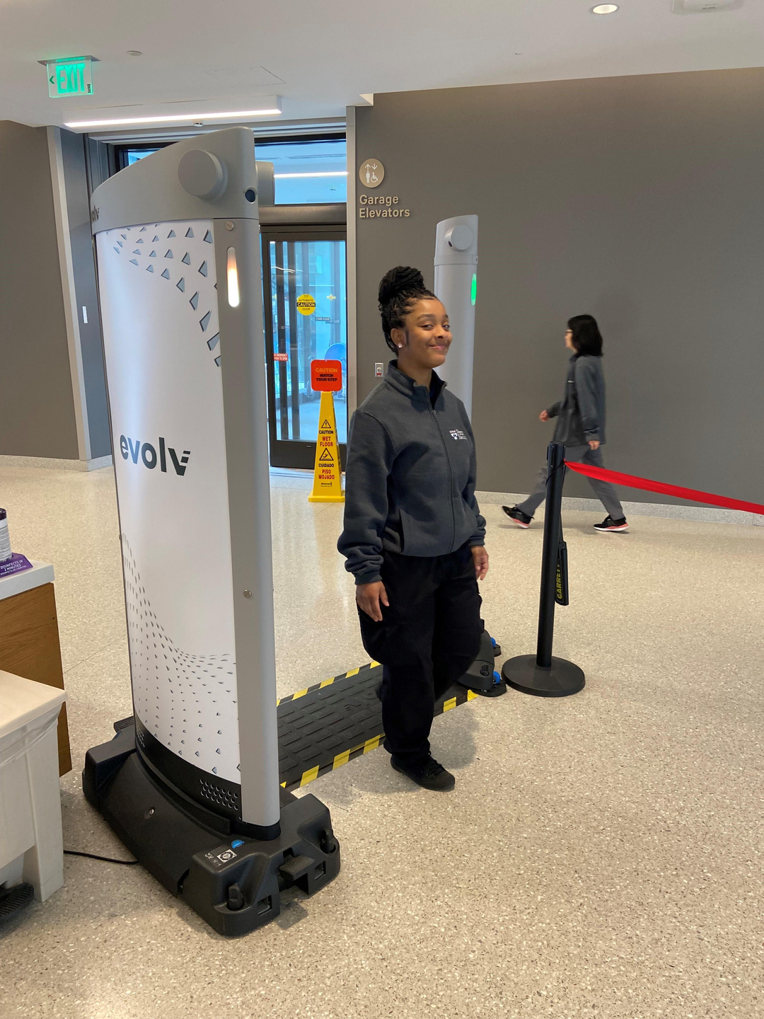 Security employee walks through an Evolv weapons detection system.
