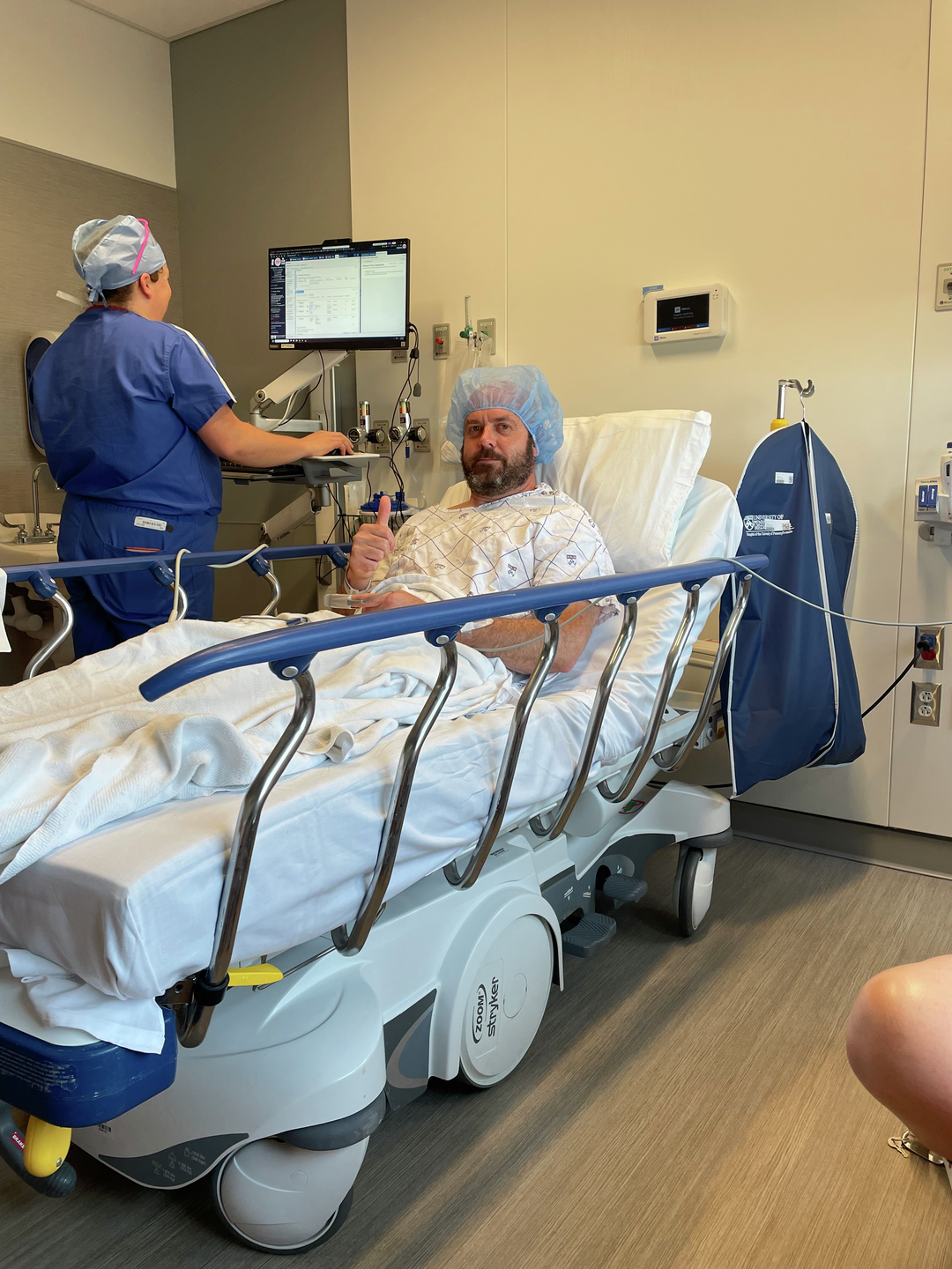 Dennis Massimo gives a thumbs up before his surgery in June 2025