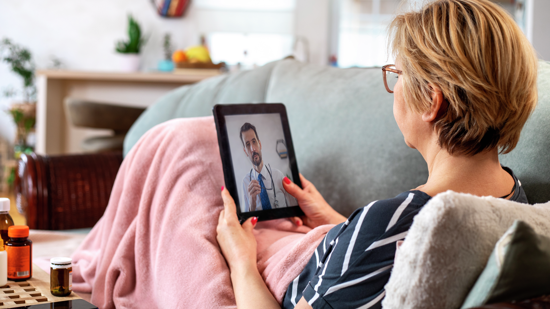 Mature woman using digital tablet for conversation with her doctor.