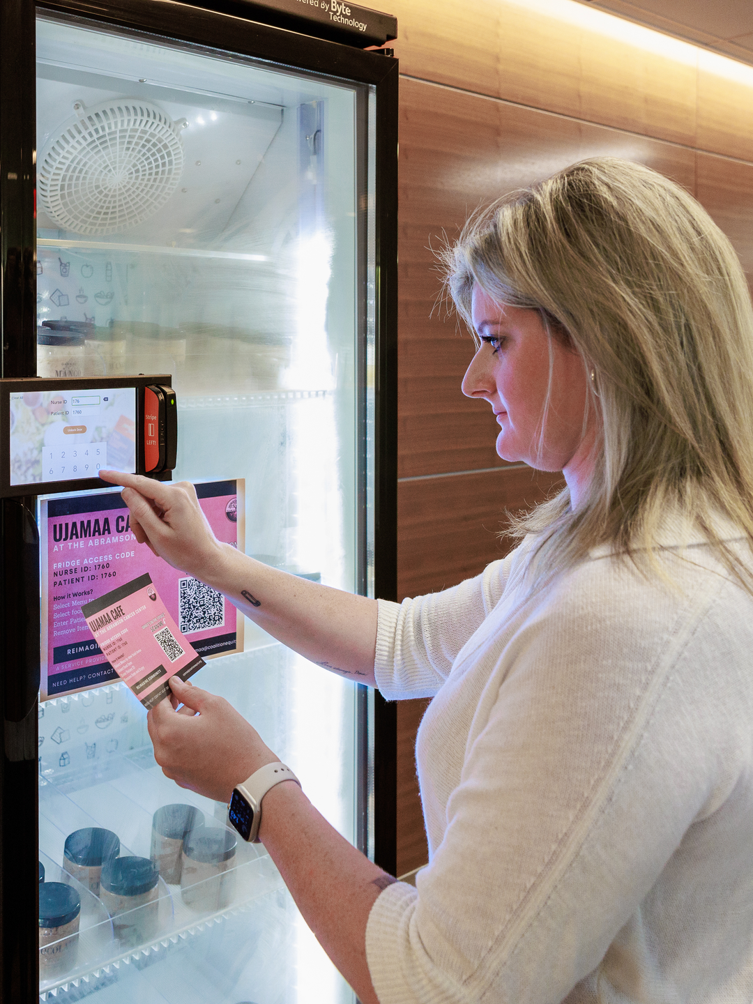 Amy Schwartz enters an access code for a community fridge