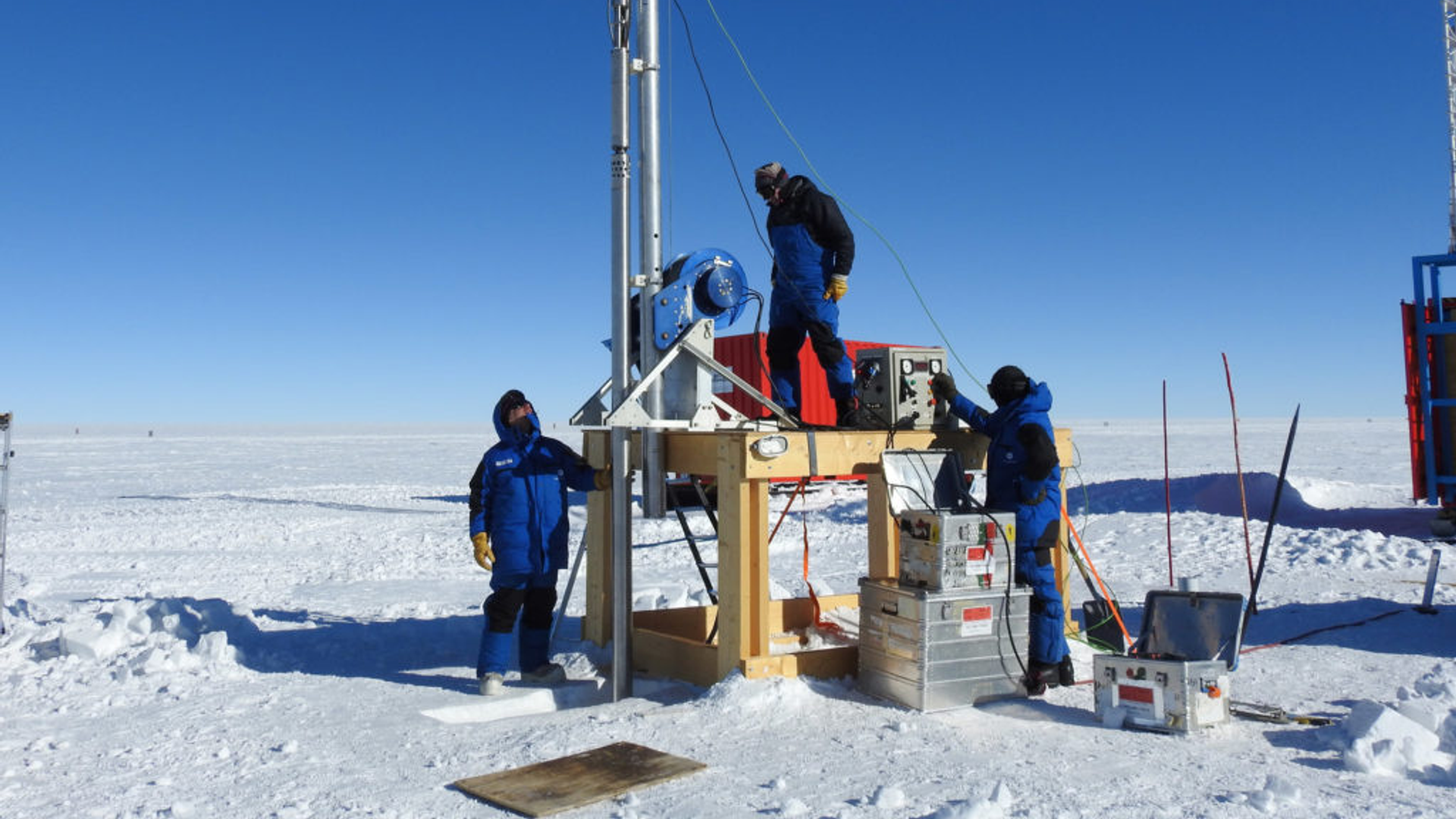 Three crewmembers working in the Antarctic 