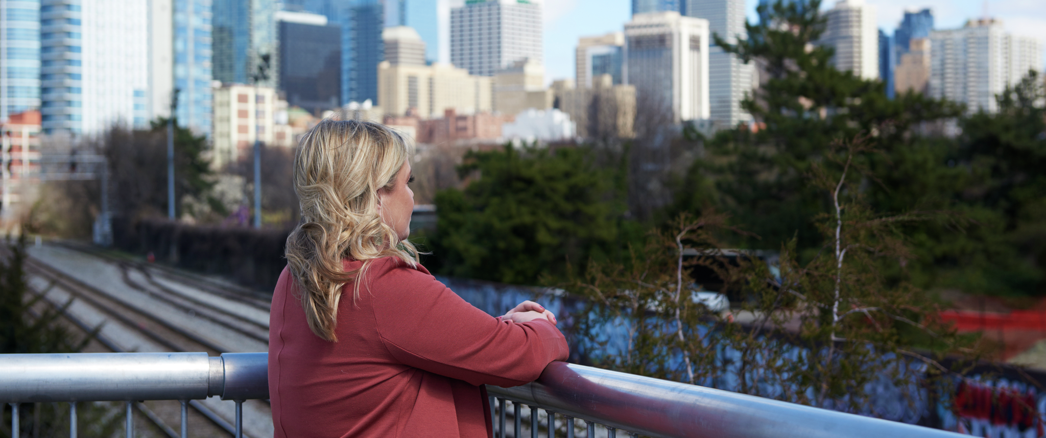 Torrey Creed, seen from behind, looks out over the Philadelphia city skyline
