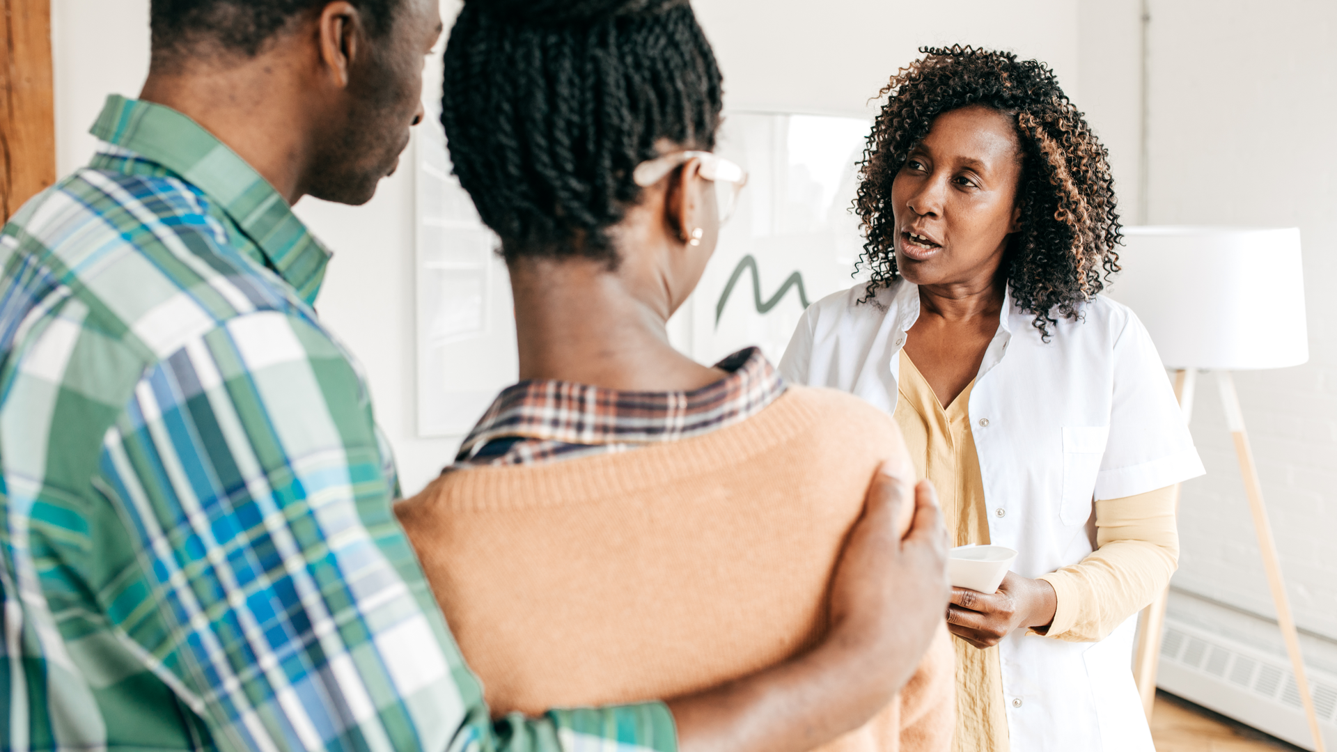 Concerned couple consulting with doctor
