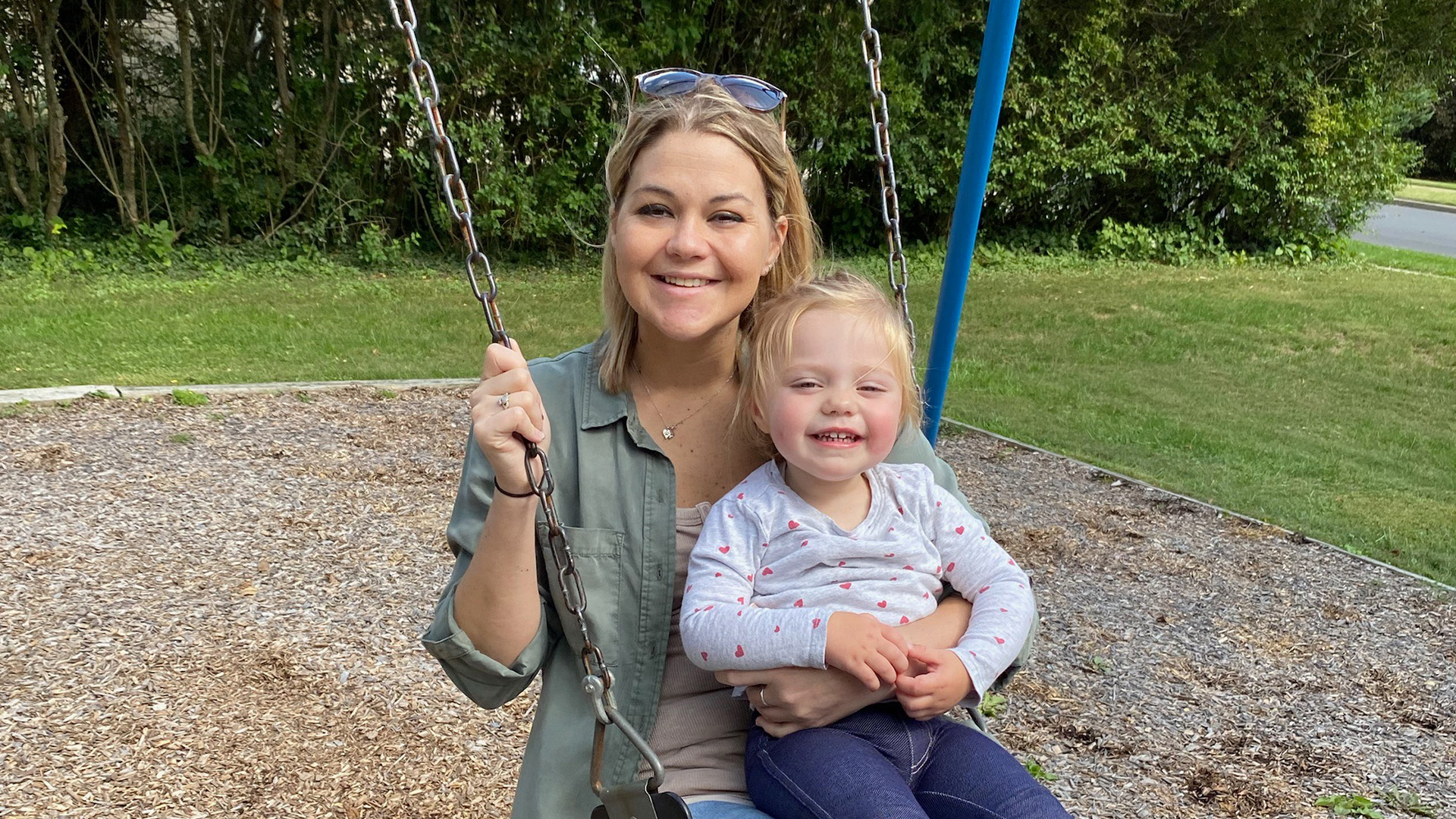 Double organ recipient of a kidney and pancreas, Jessica Bonkoski, on swing set with her child