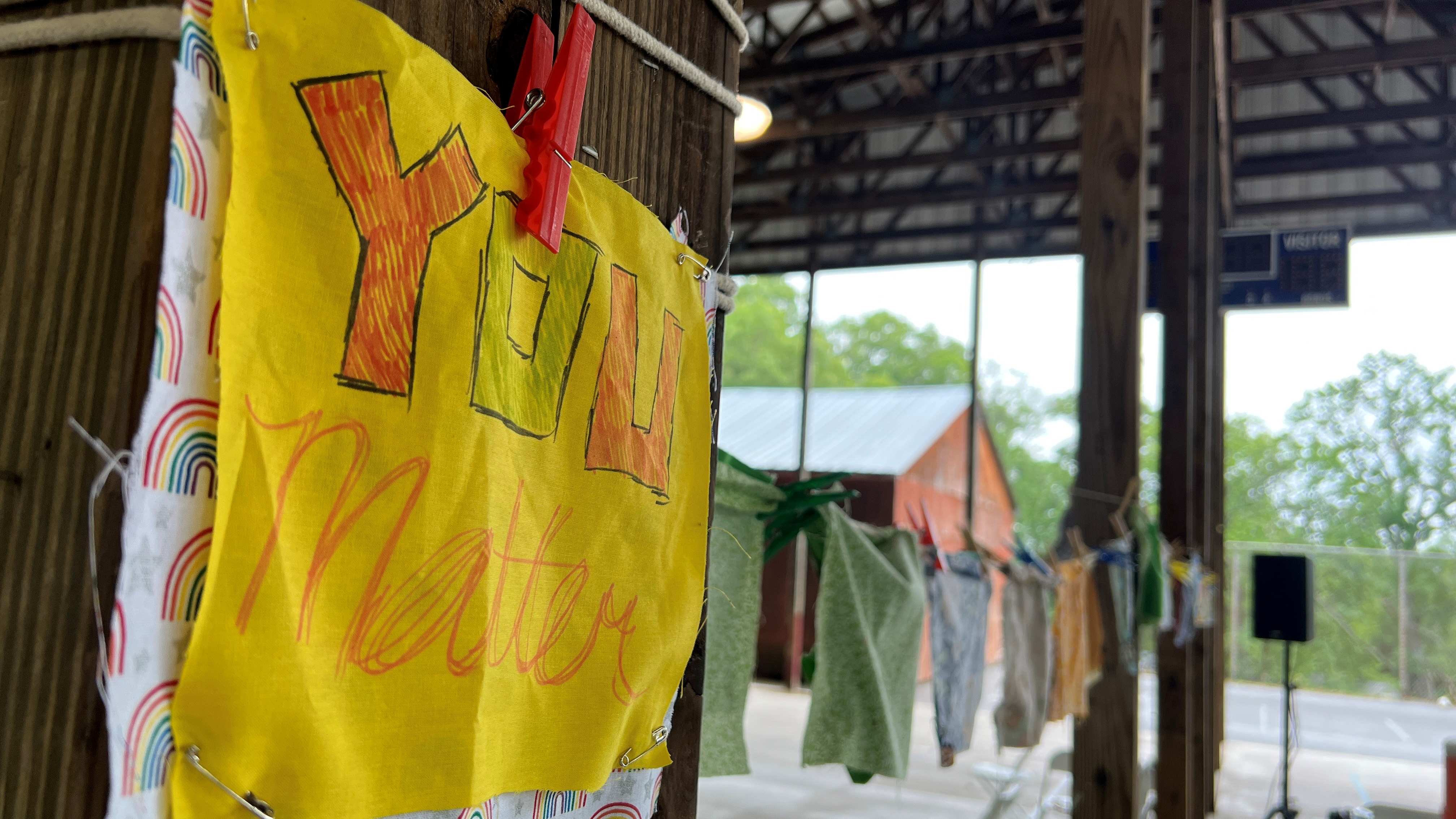 A piece of cloth reading You Matter is hung on a line at Camp Erin