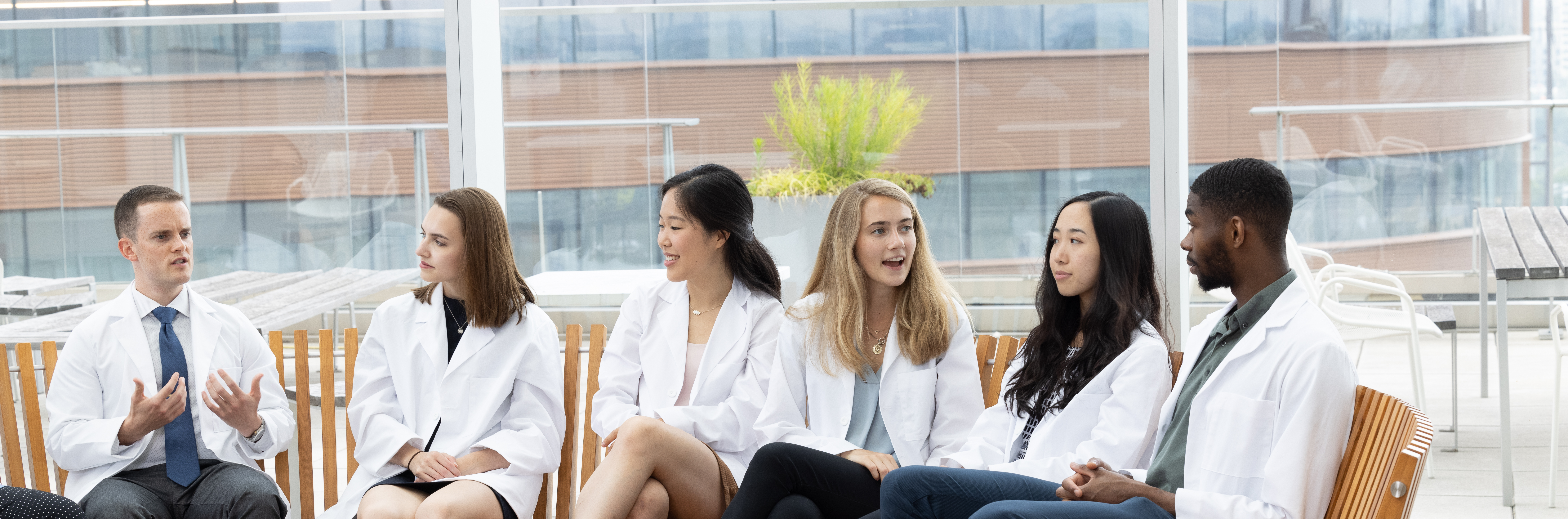 Medical students at the Perelman School of Medicine having discussion on bench