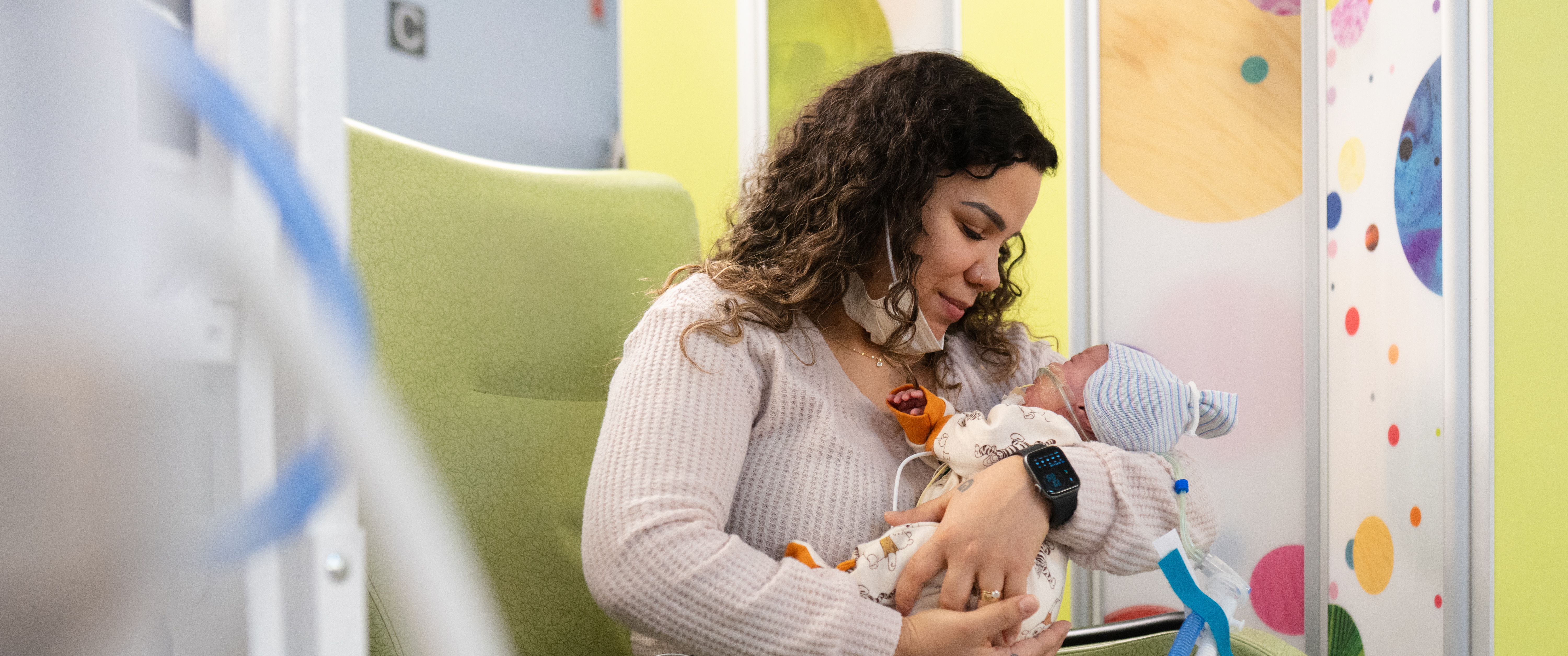 Pamela Collins holding her baby, John, who is wearing the Sonura Beanie.