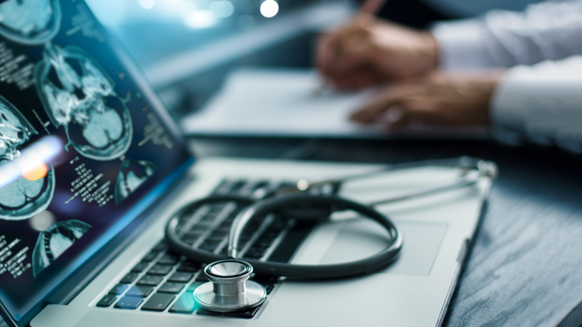 Brain scan results on laptop screen with stethoscope on keyboard