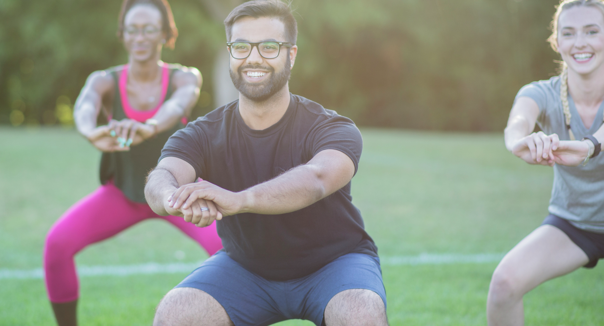 People exercising together doing squats.