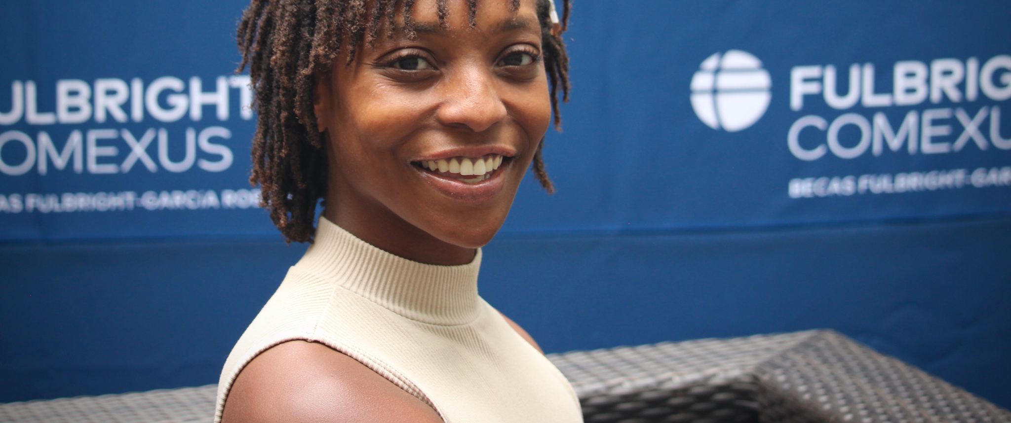 Zonia Moore in front of a blue Fulbright-branded backdrop