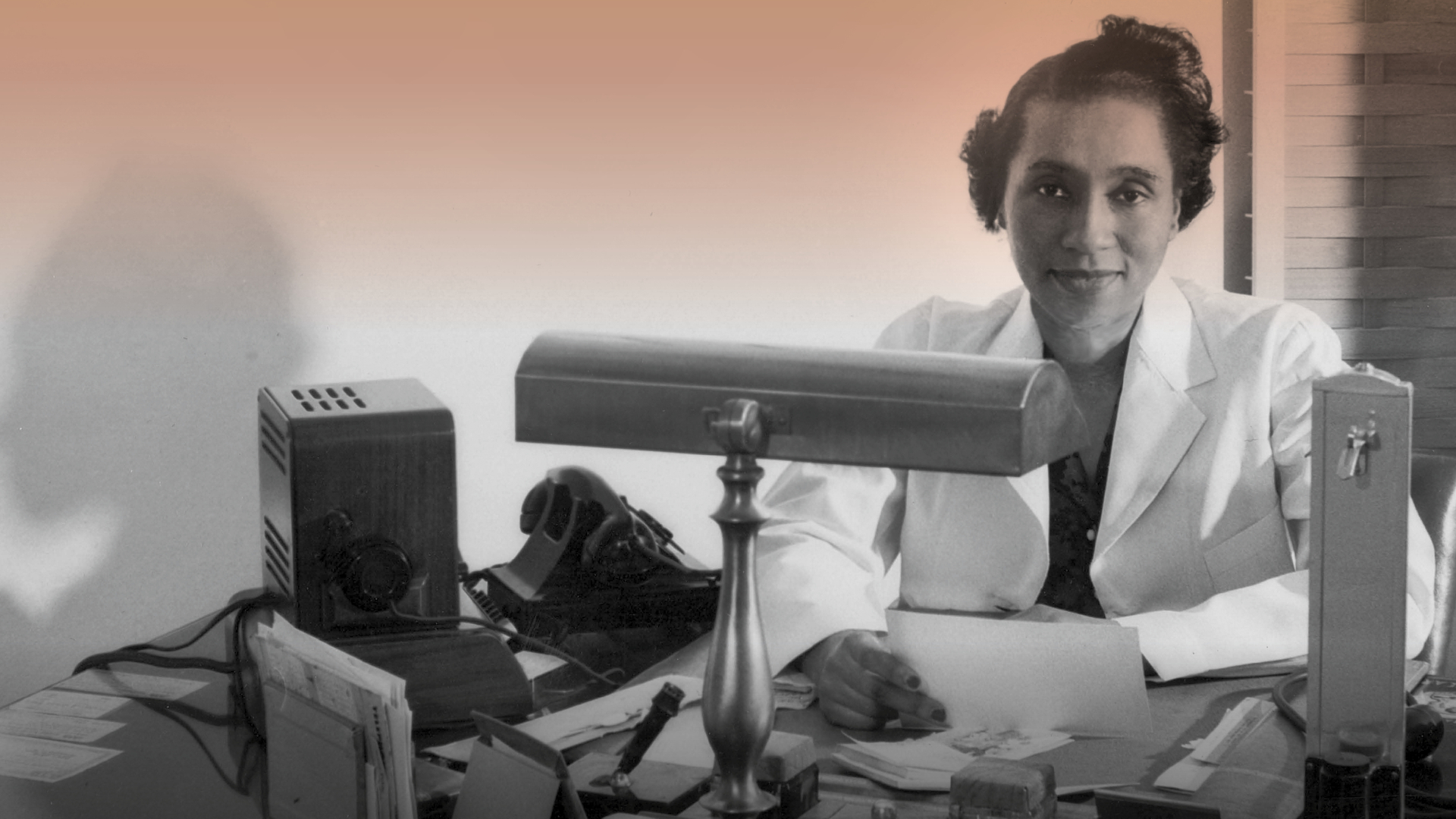 A portrait shows Helen O. Dickens in 1947, wearing a white coat and seated at her desk, with a serene expression.