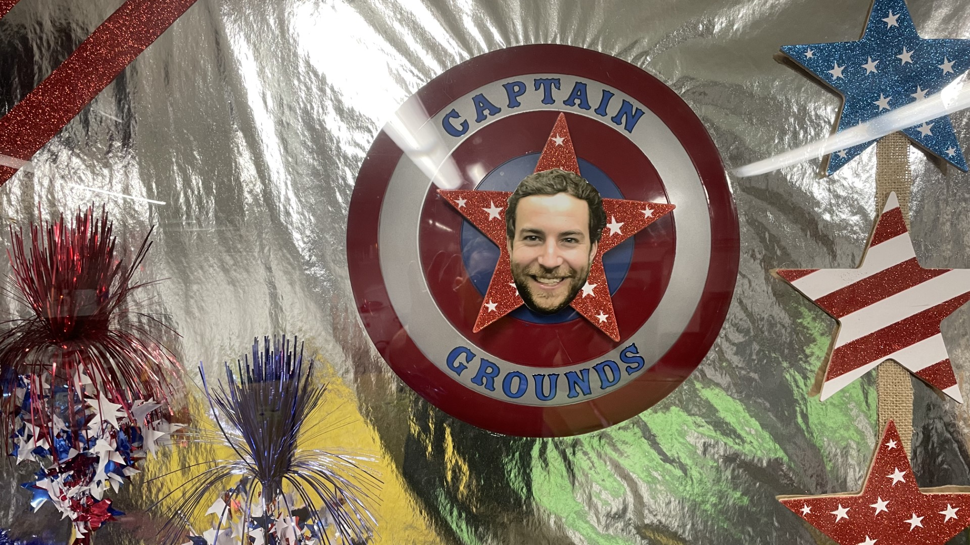 A red, white, and blue shield decorated with the phrase “Captain Grounds” with a photo of Blake Sieminski in its center