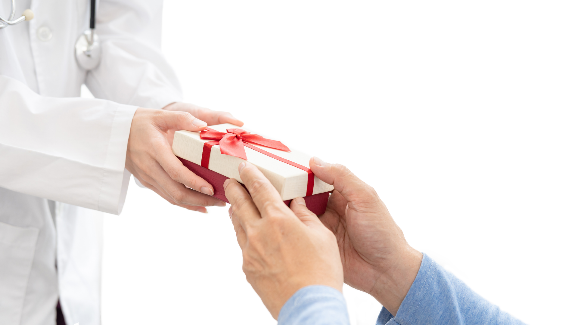 A doctor in a white coat handing a red and white wrapped gift to a patient just outside of the frame