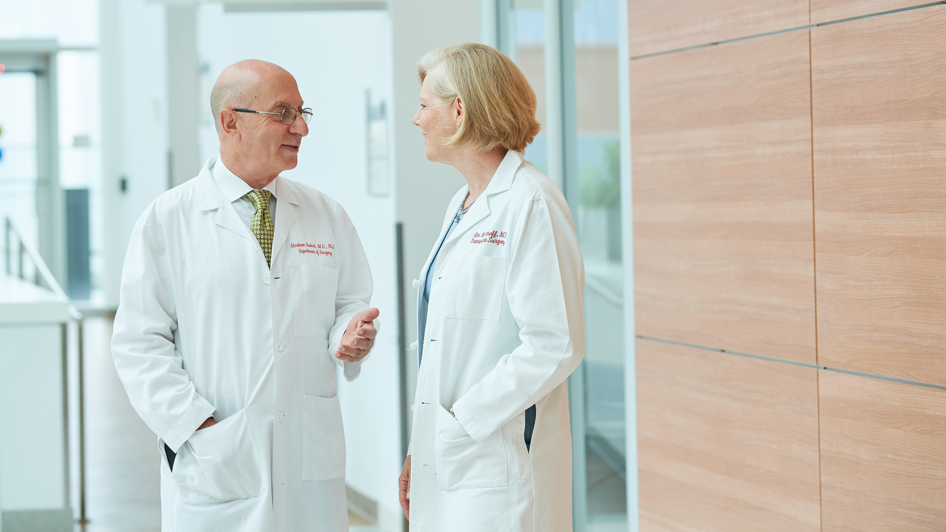 Director of the Penn Transplant Institute, Abraham Shaked, MD, PhD, and  Chief of the Division of Transplant Surgery, Kim M. Olthoff, MD, talking in the hallway at the Perelman Center for Advanced Medicine