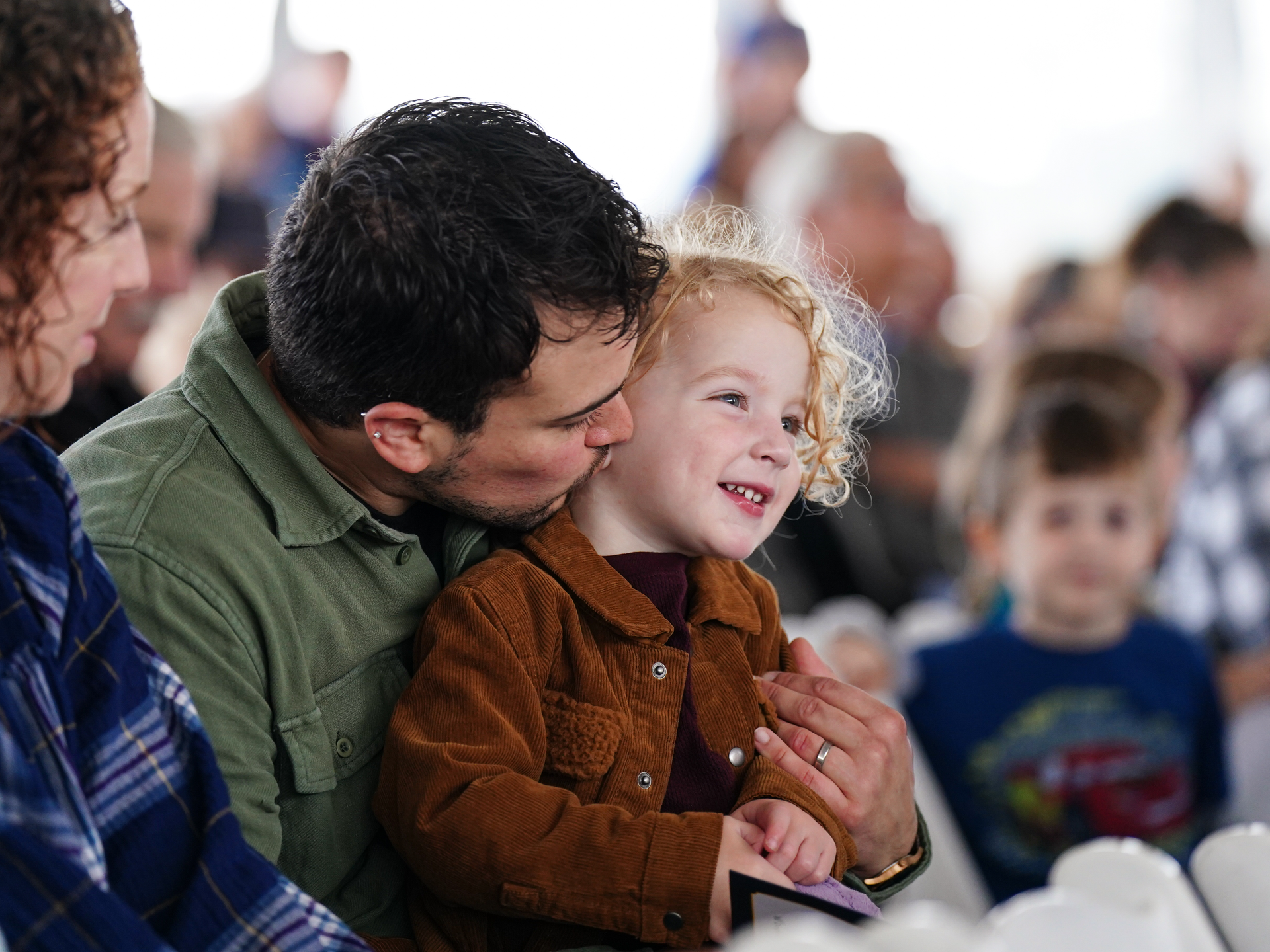 Parents and child attending a Children's Village event