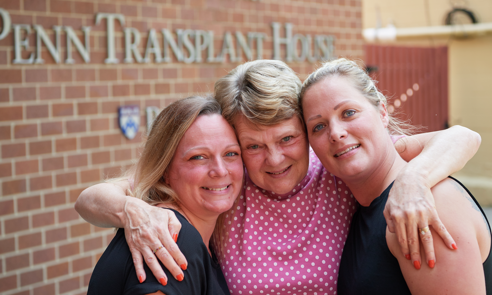 Penn Transplant patient and family embracing outside the Clyde F. Barker Penn Transplant House
