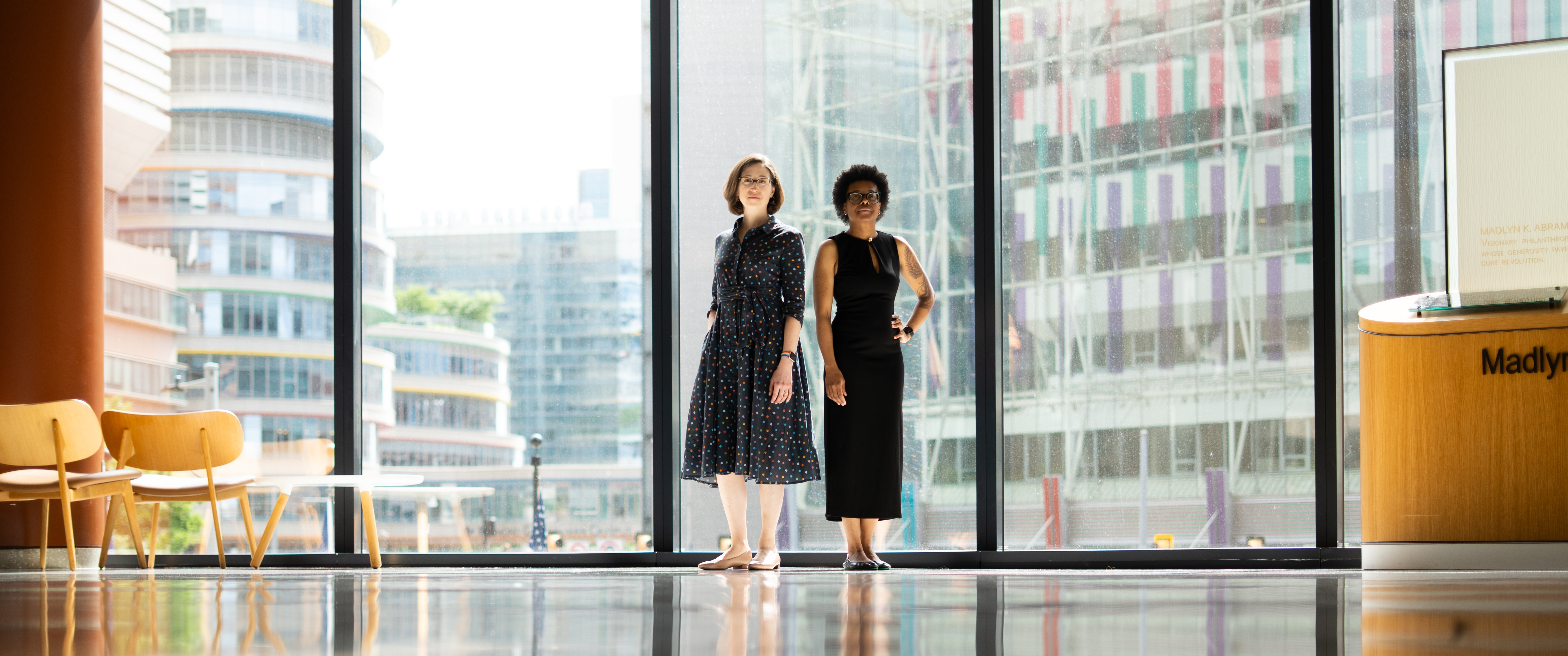 Katie Dalke, MD, and Dovie Watson, MD, stand in front of large windows of the Clifton Center